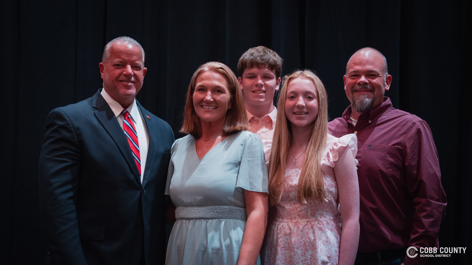 Ashley Talton posing for a picture with her family 