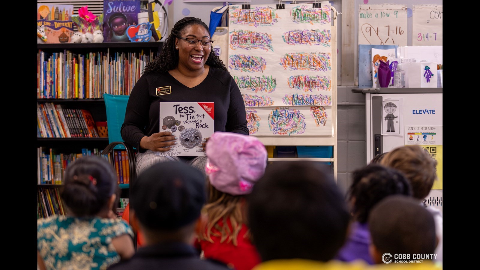Cobb Schools Board Member Nichelle Davis shares the joy of reading with students during a Read Across Cobb event, inspiring young learners to explore new stories and ideas.