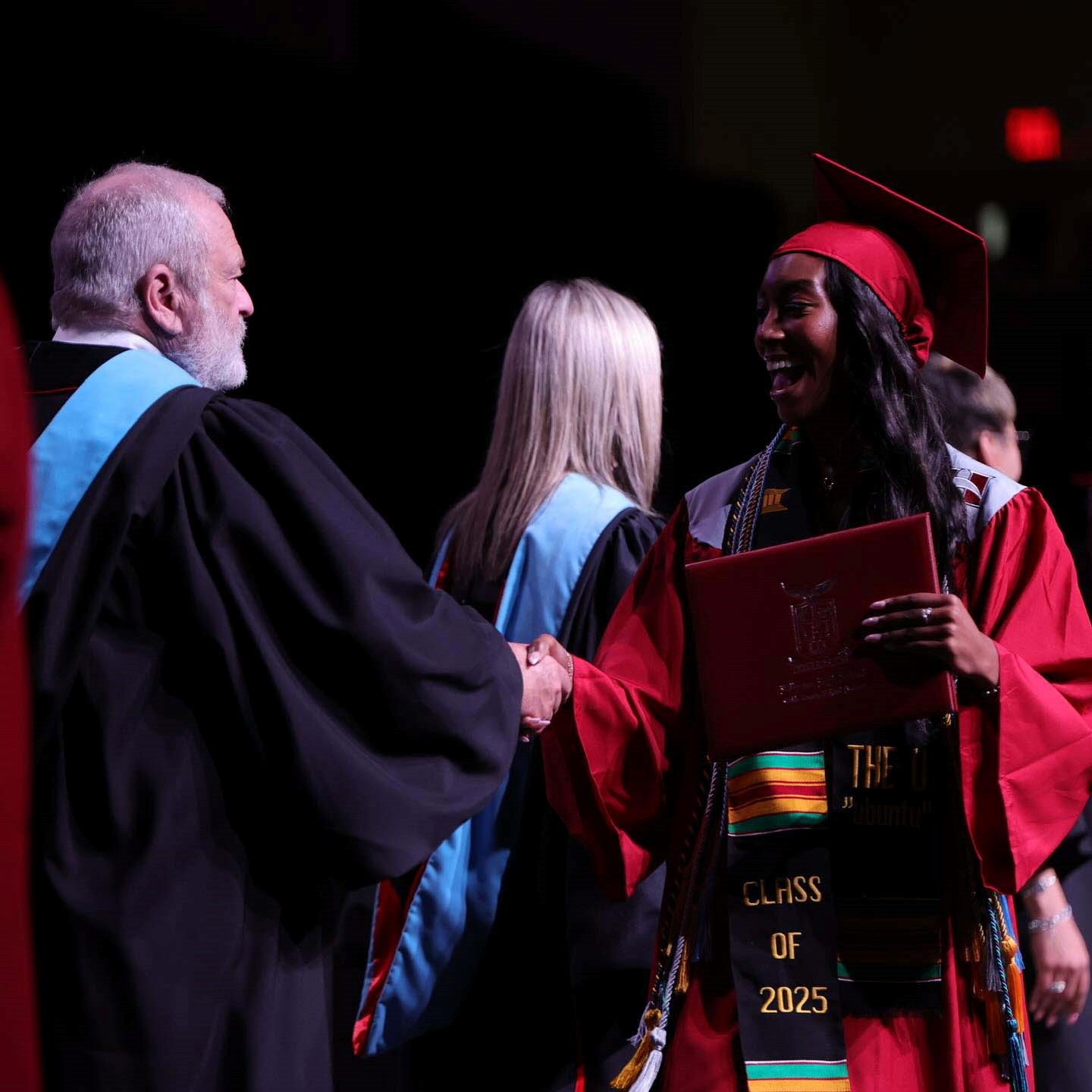 Cobb Schools Board Member Brad Wheeler congratulates a graduate of Hillgrove High School.