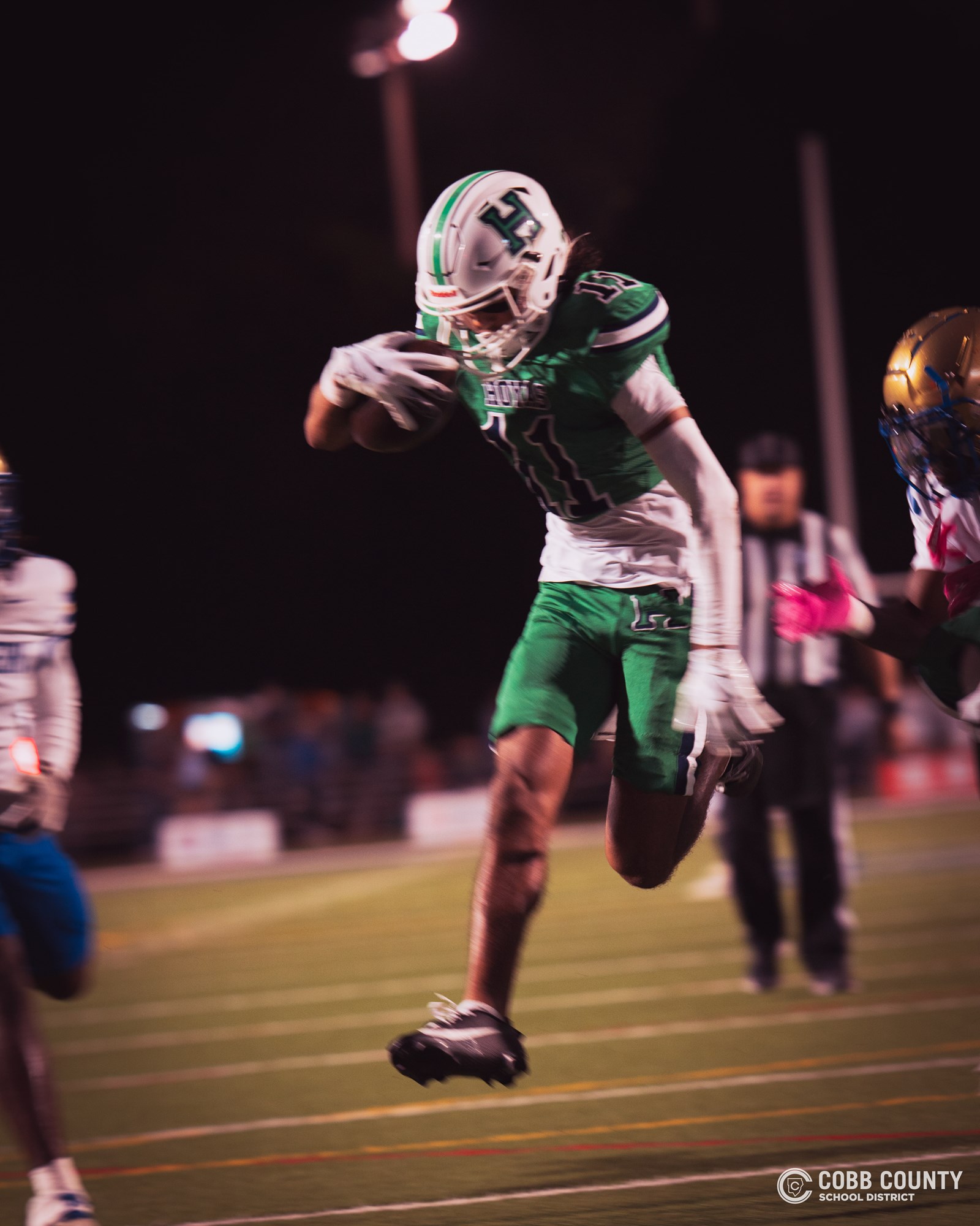 Harrison senior receiver DJ Huggins leaps for more yardage