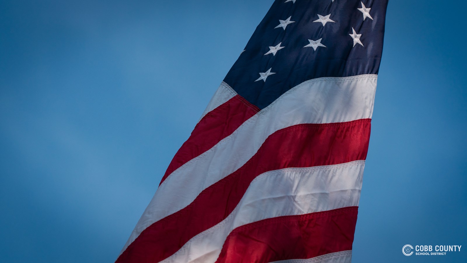 The American flag flies during the 9/11 ceremony at Kennesaw Mountain High School