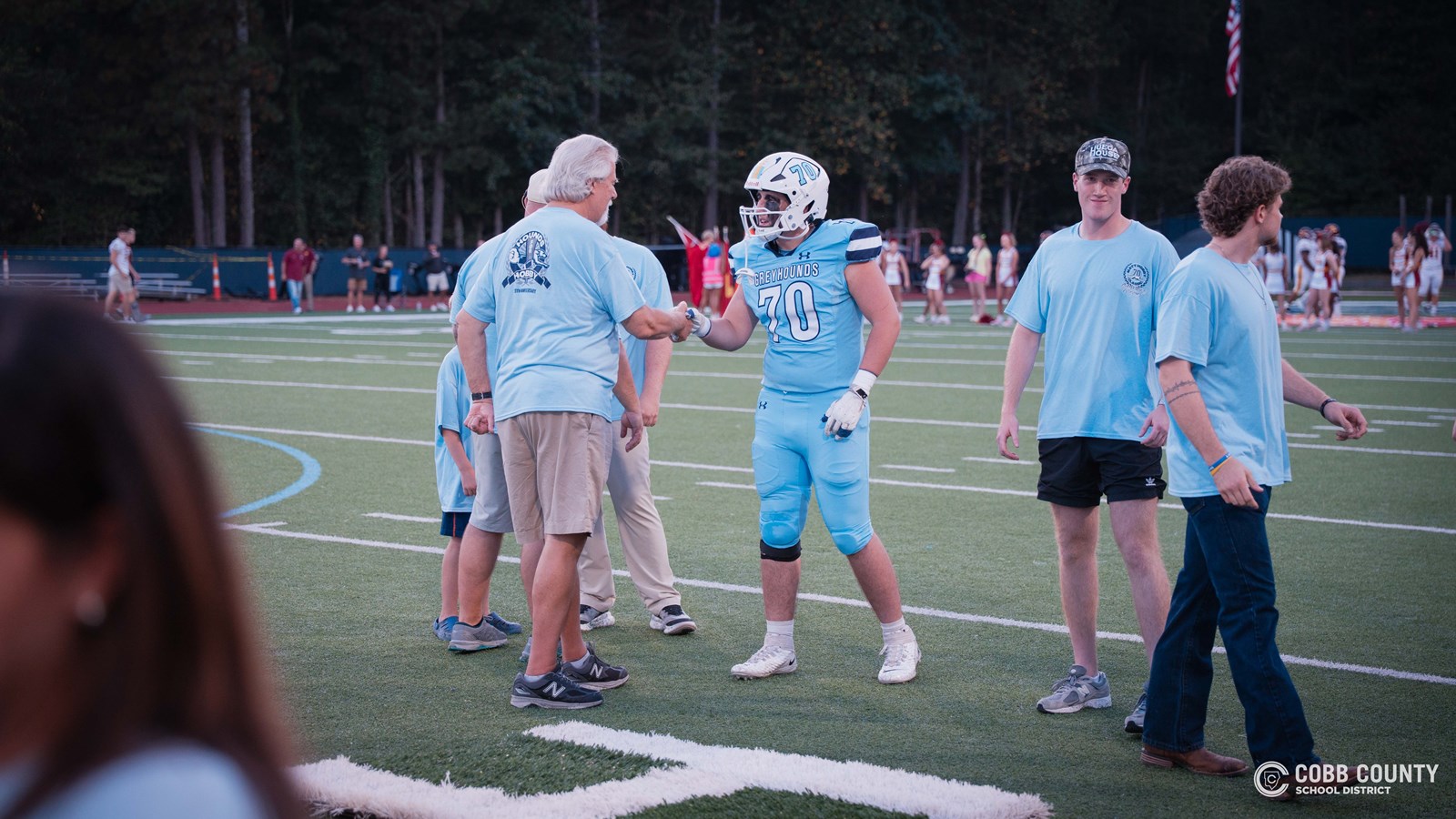 Mr. Hobby greets James Burns, the 2025 recipient of the #70 jersey