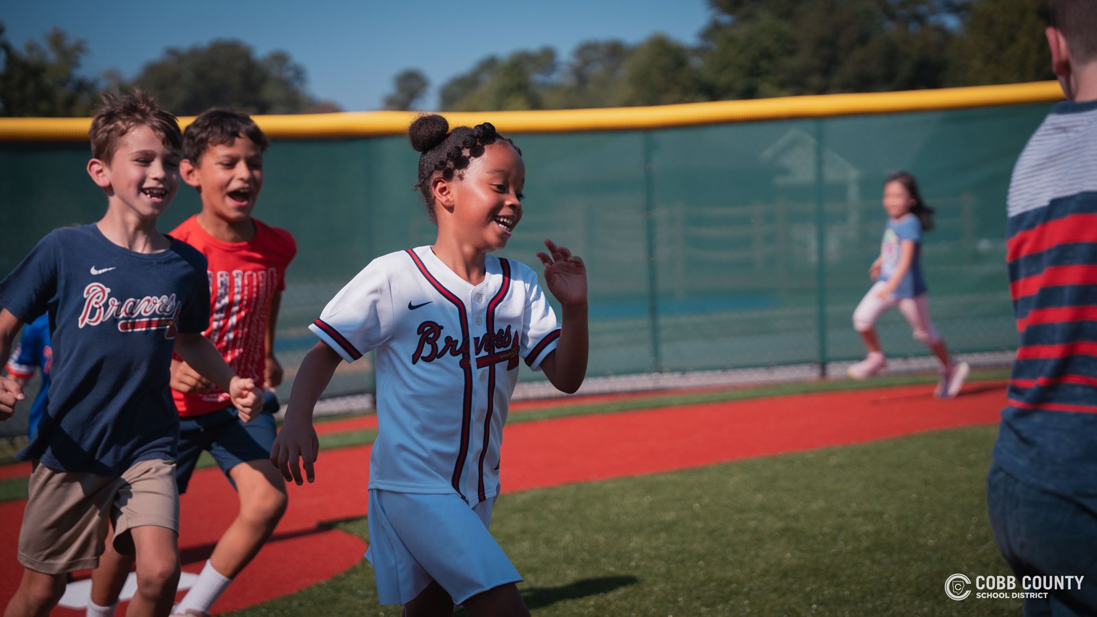 Students running the bases of new Braves miniature stadium 