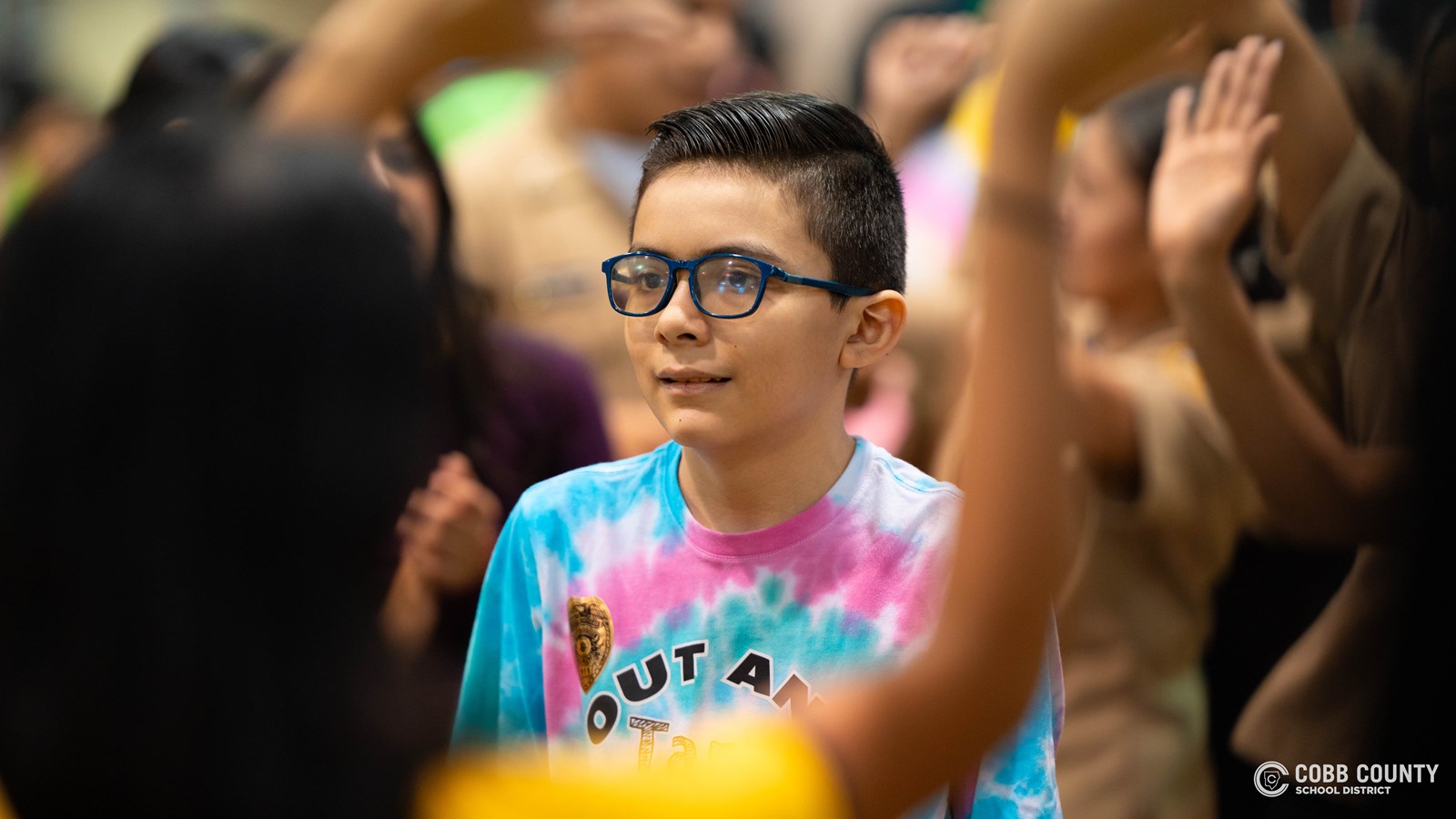 A student embraces every moment of fun and celebration with a big smile at Kennesaw Mountain High School’s annual dance for students with special needs!