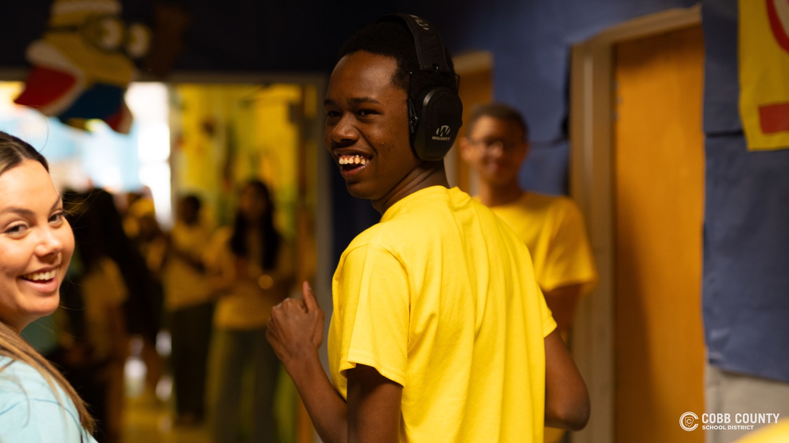 A student embraces every moment of fun and celebration with a big smile at Kennesaw Mountain High School’s annual dance for students with special needs!