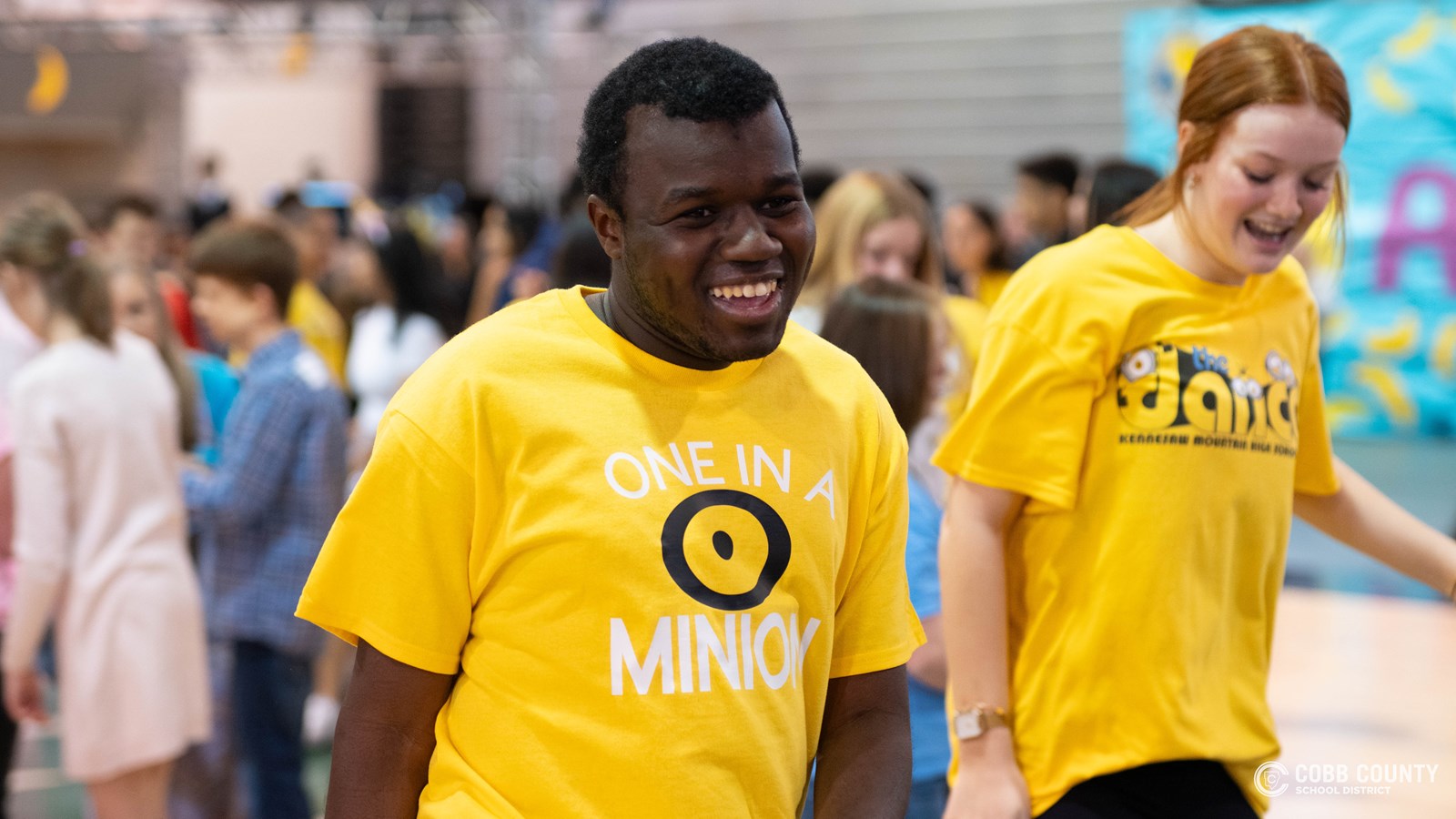 A student embraces every moment of fun and celebration with a big smile at Kennesaw Mountain High School’s annual dance for students with special needs!