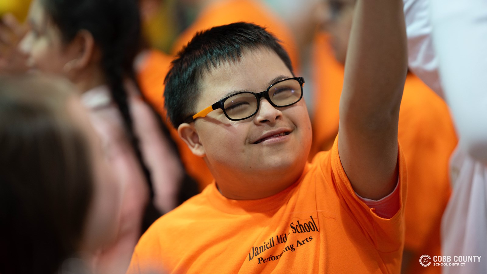 A student embraces every moment of fun and celebration with a big smile at Kennesaw Mountain High School’s annual dance for students with special needs!