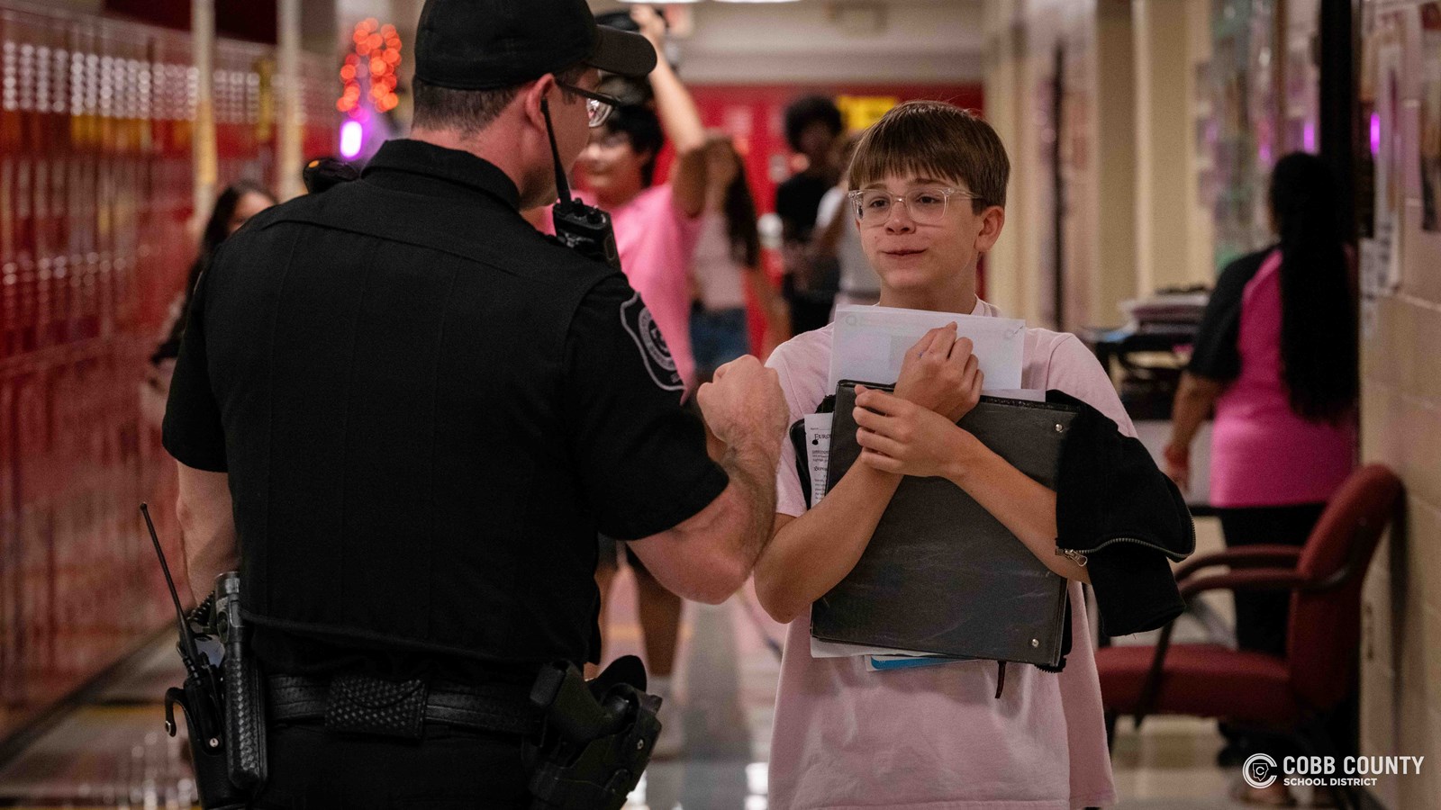 Officer Hurley fist bumps student