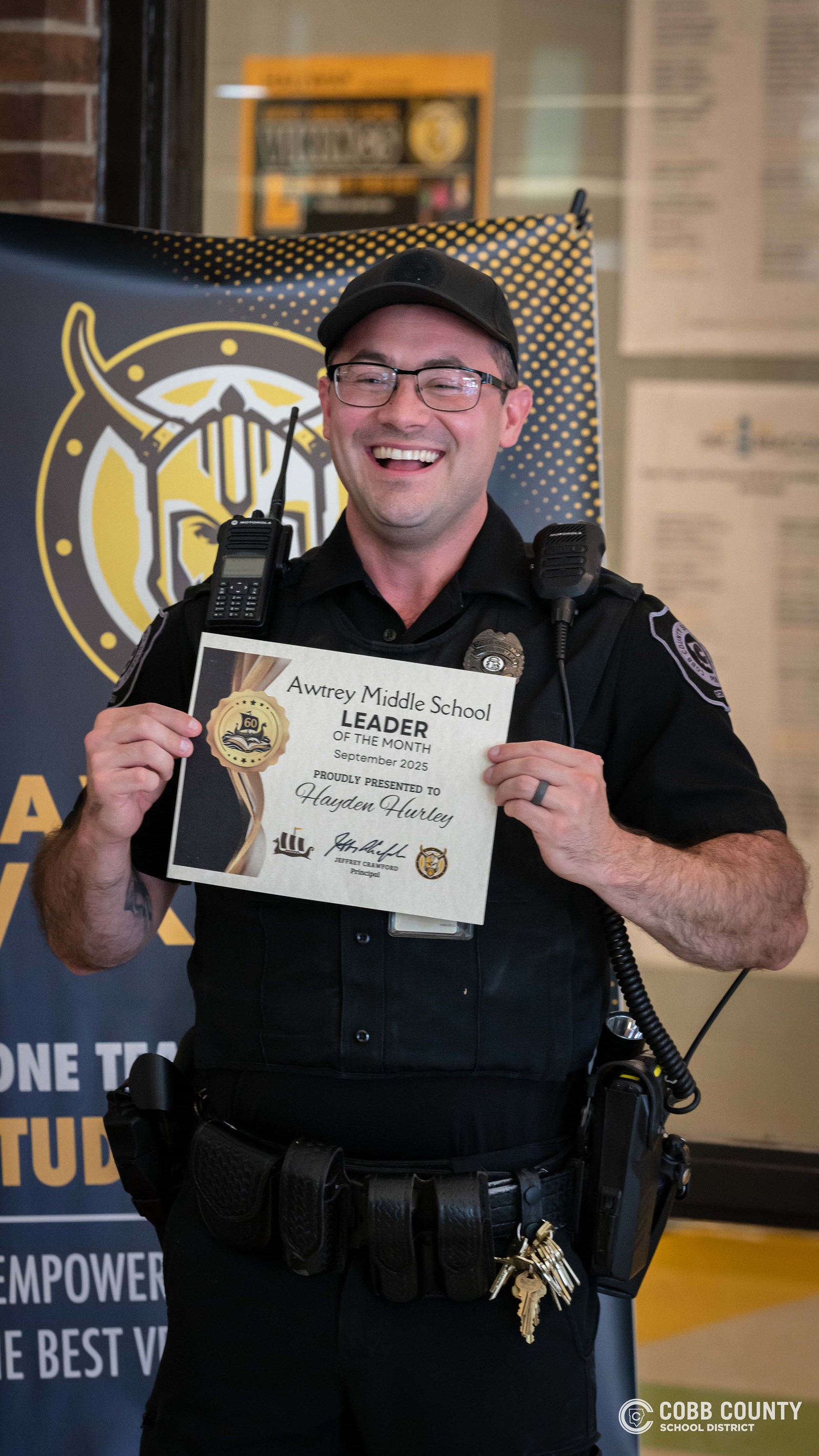 Officer Hurley holding up leadership award