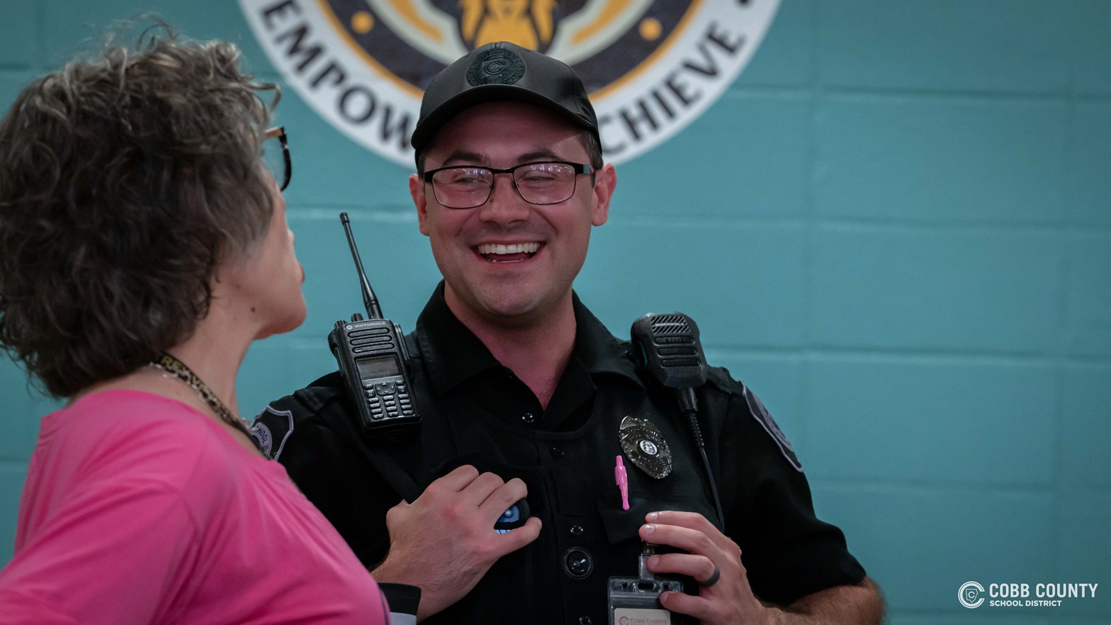 Officer Hurley laughs with staff 