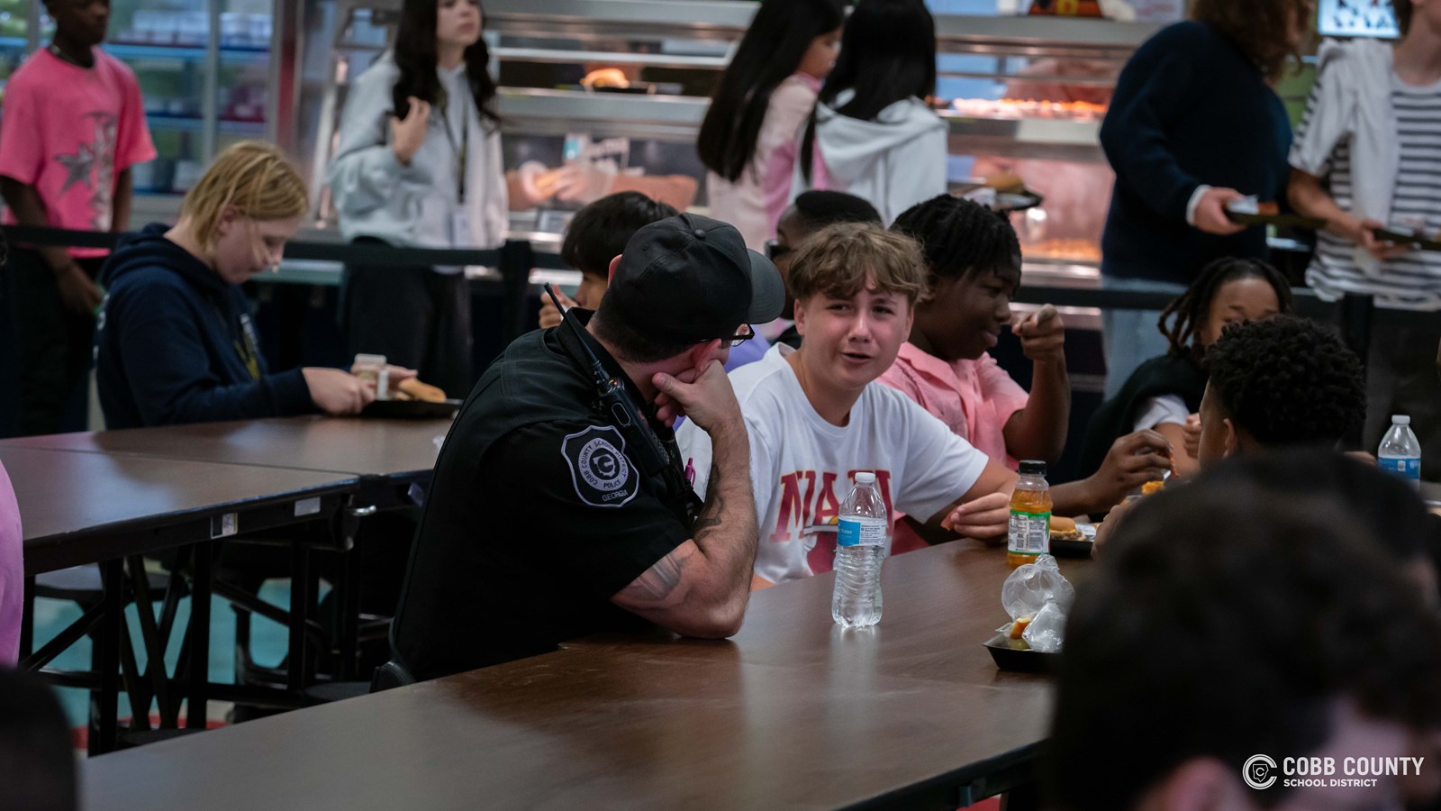 Officer Hurley in cafeteria 
