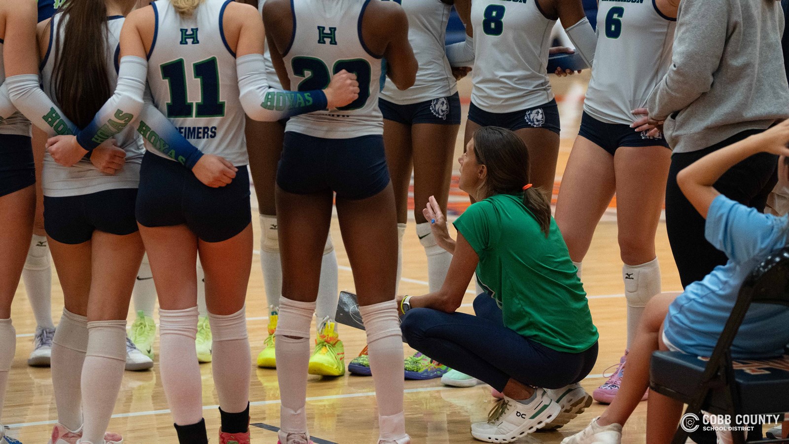 Coach Johnson prepares her team for a match