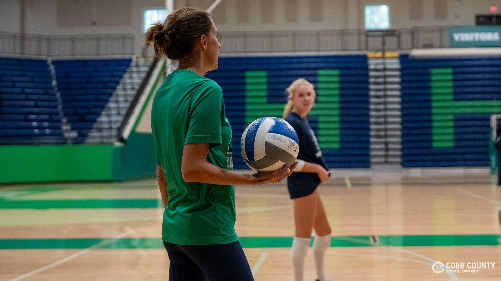 Coach Johnson in practice, Addison Cooley listens to instructions