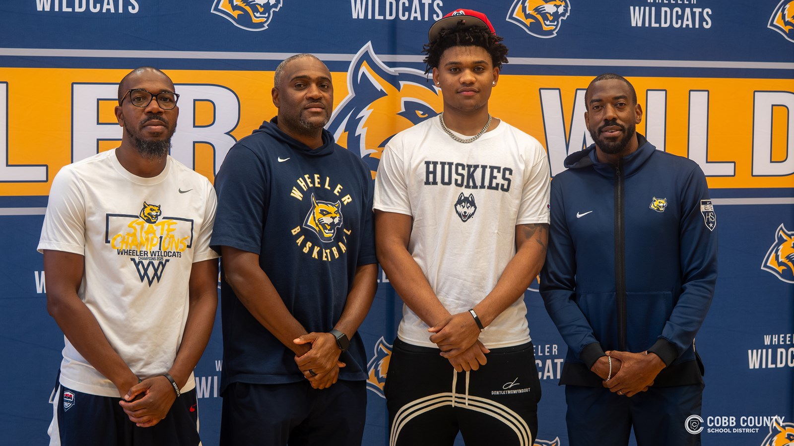 Colben Landrew poses with his Wheeler basketball coaches