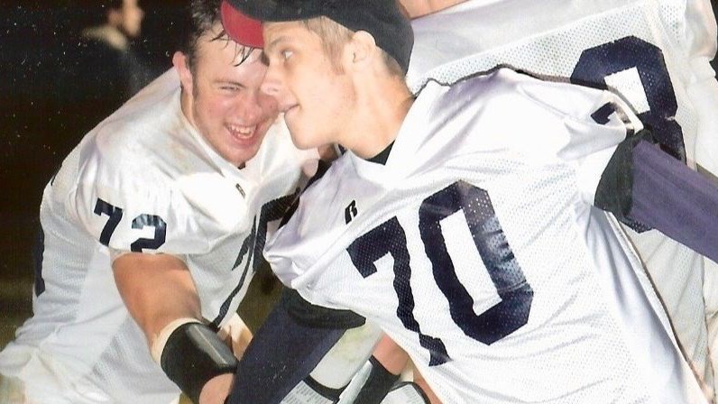 Matt Hobby (70) celebrating with teammates