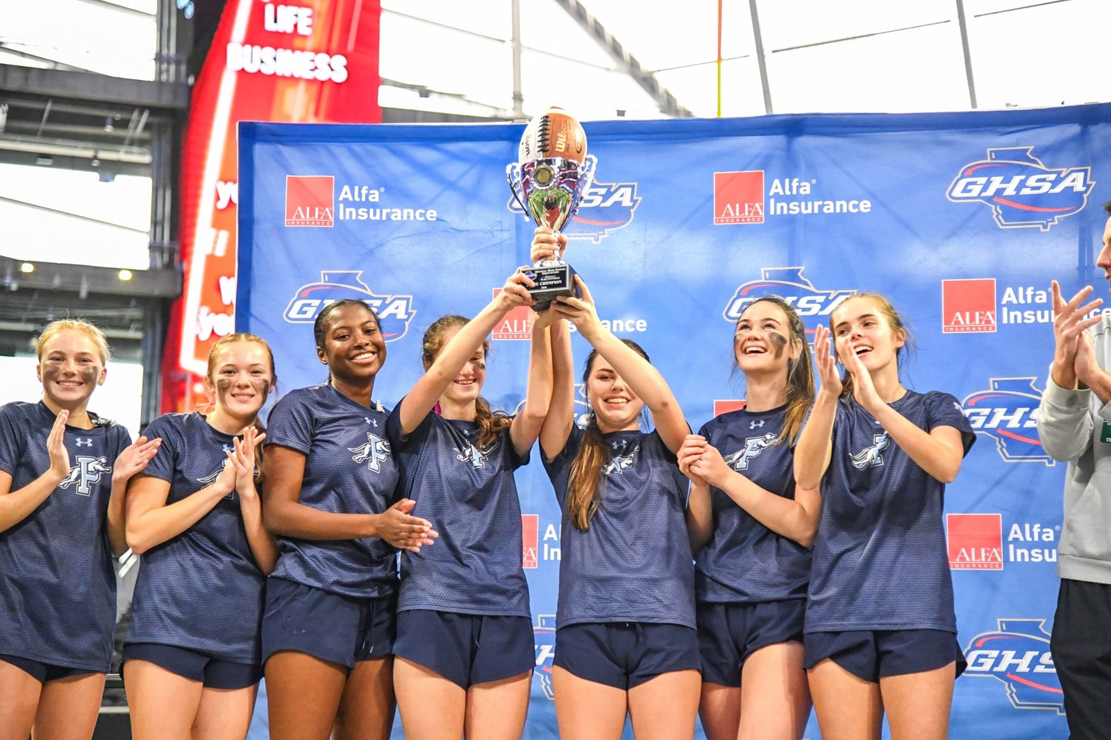 flag football seniors with trophy