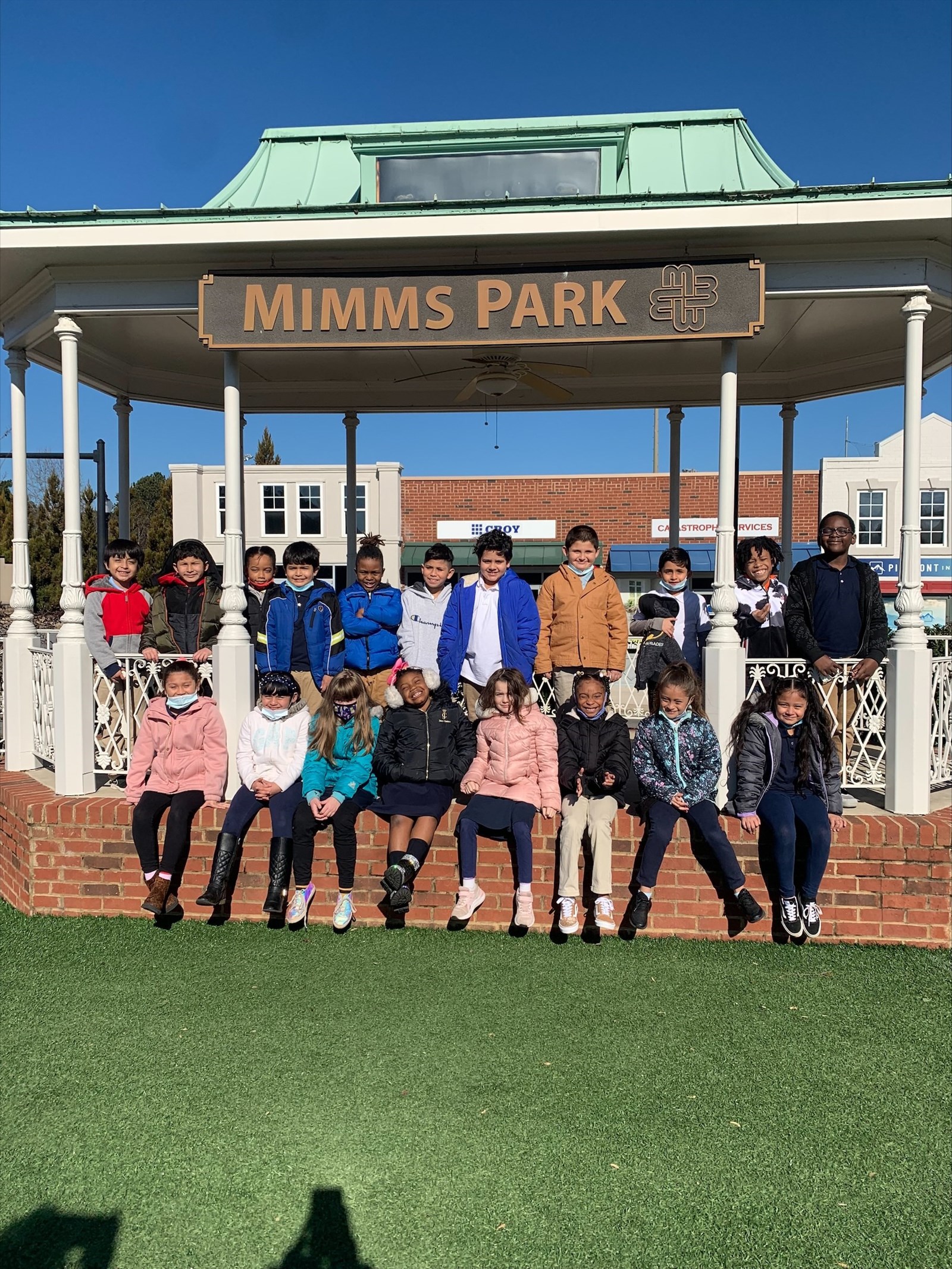 Students sitting at model gazebo