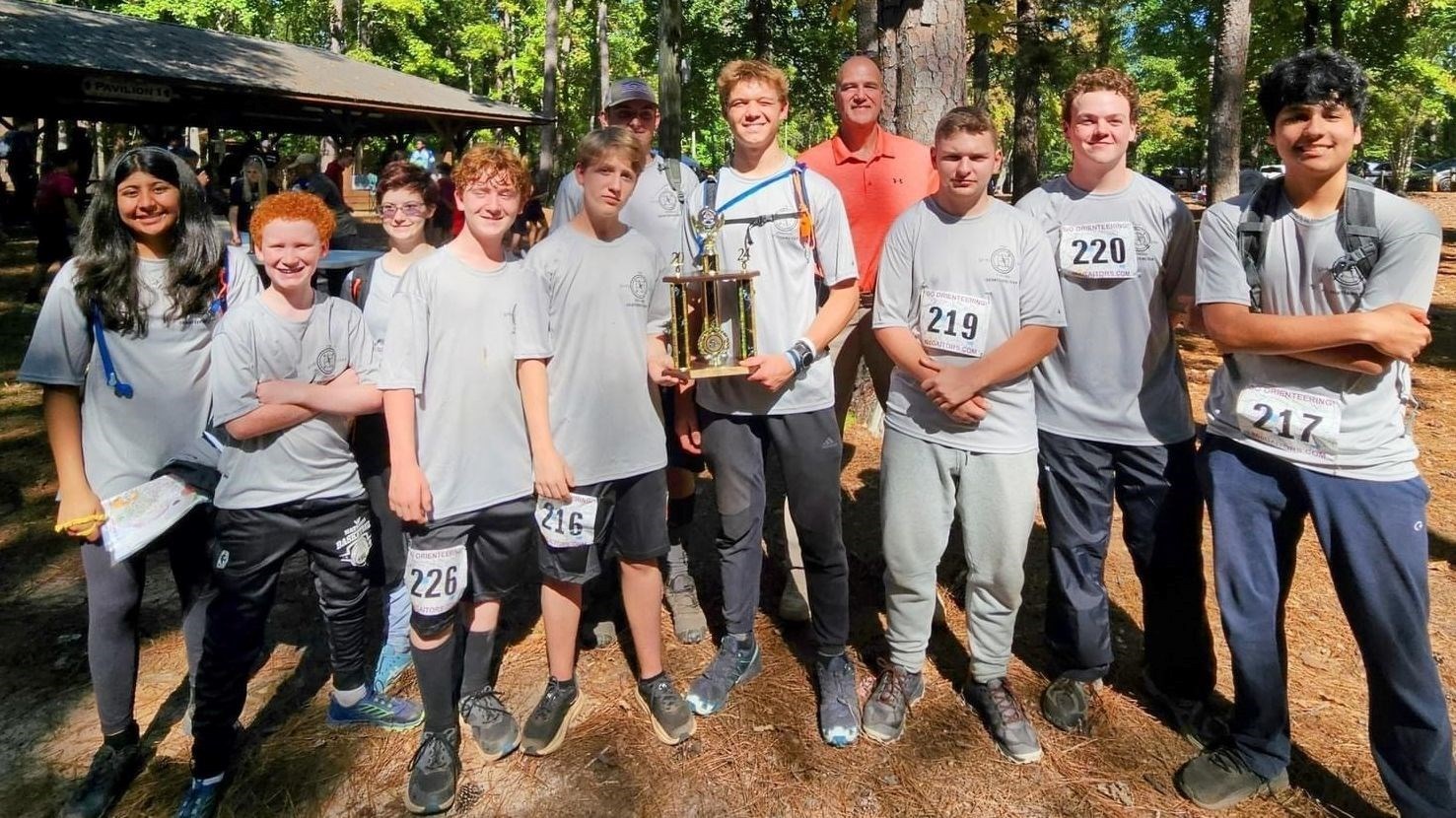 NJROTC students orienteering with a trophy