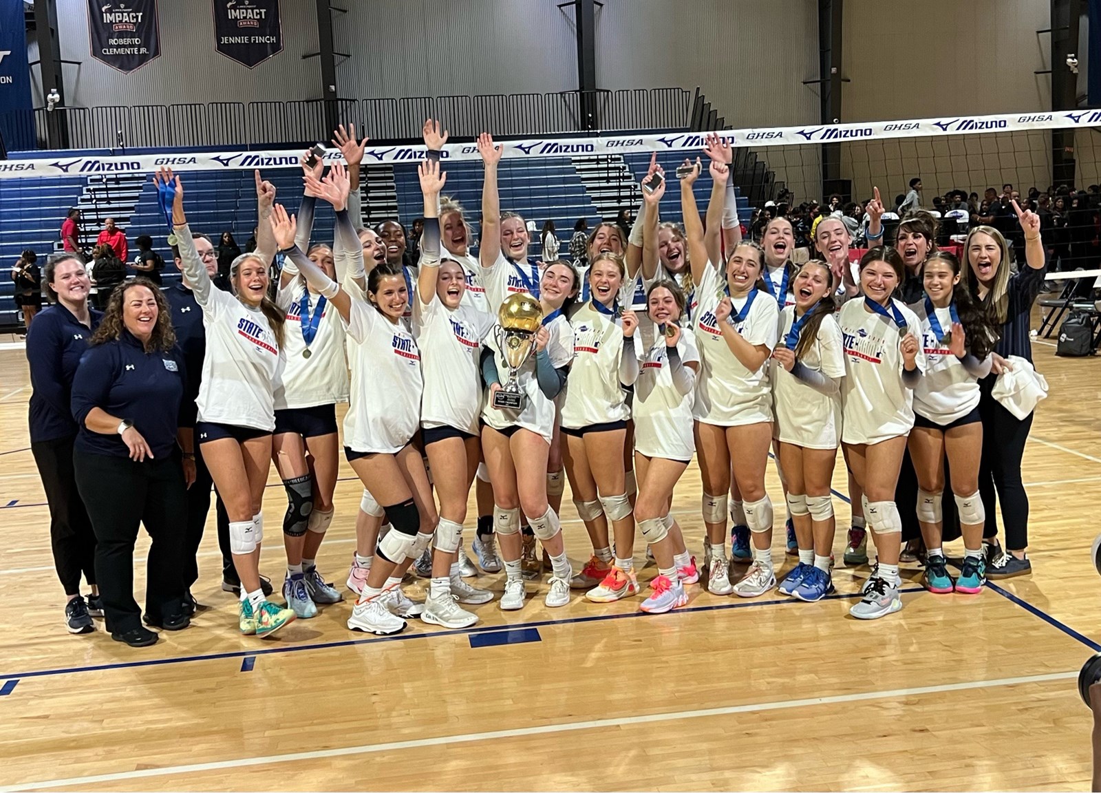 pope volleyball team celebrating after state championship victory