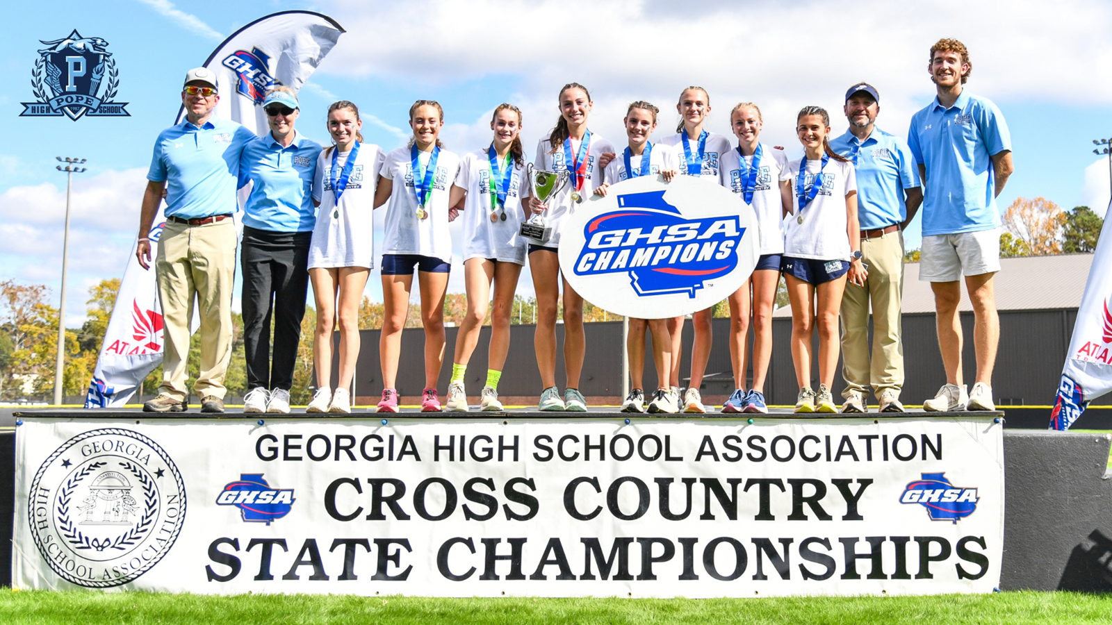 girls cross country team with coaches