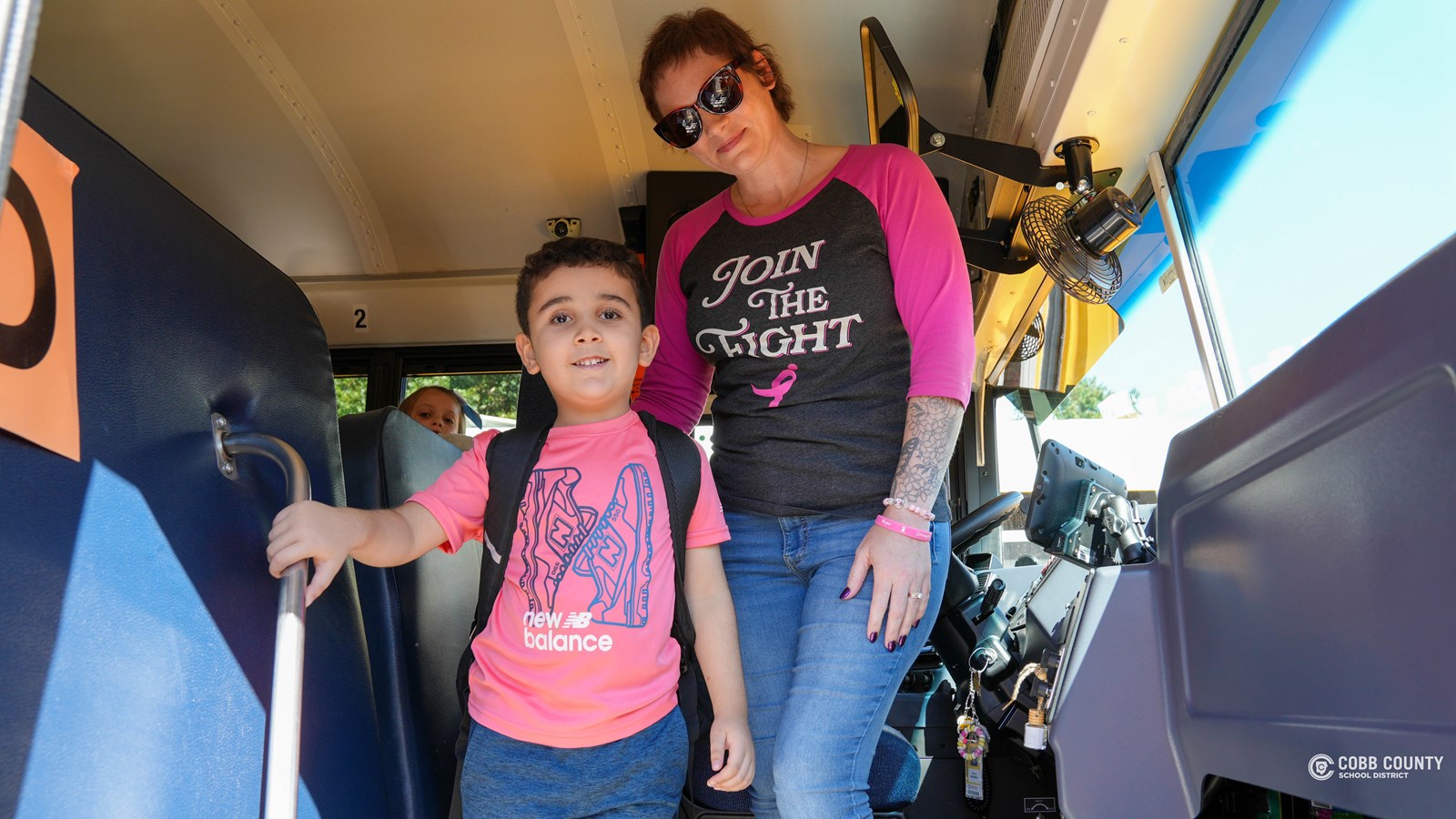 Moraweic with her students at Pitner Elementary as they board the bus.