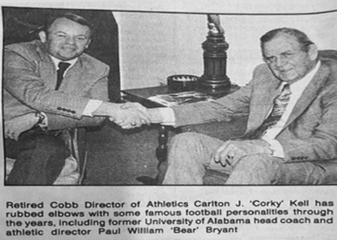 Newspaper photo of Corky Kell shakes hands with legendary college football coach Bear Bryant