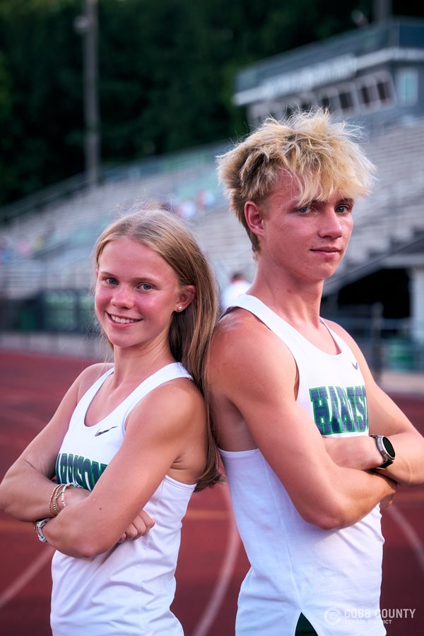 Paige and Riley Comstock pose in their Harrison High School running gear