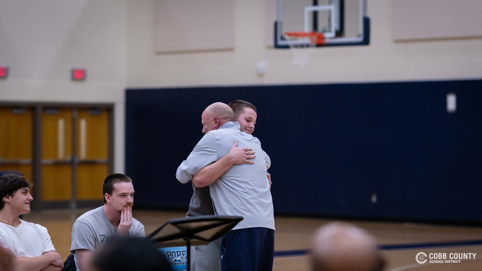 Pope coach Pat Abney hugs his son Drew