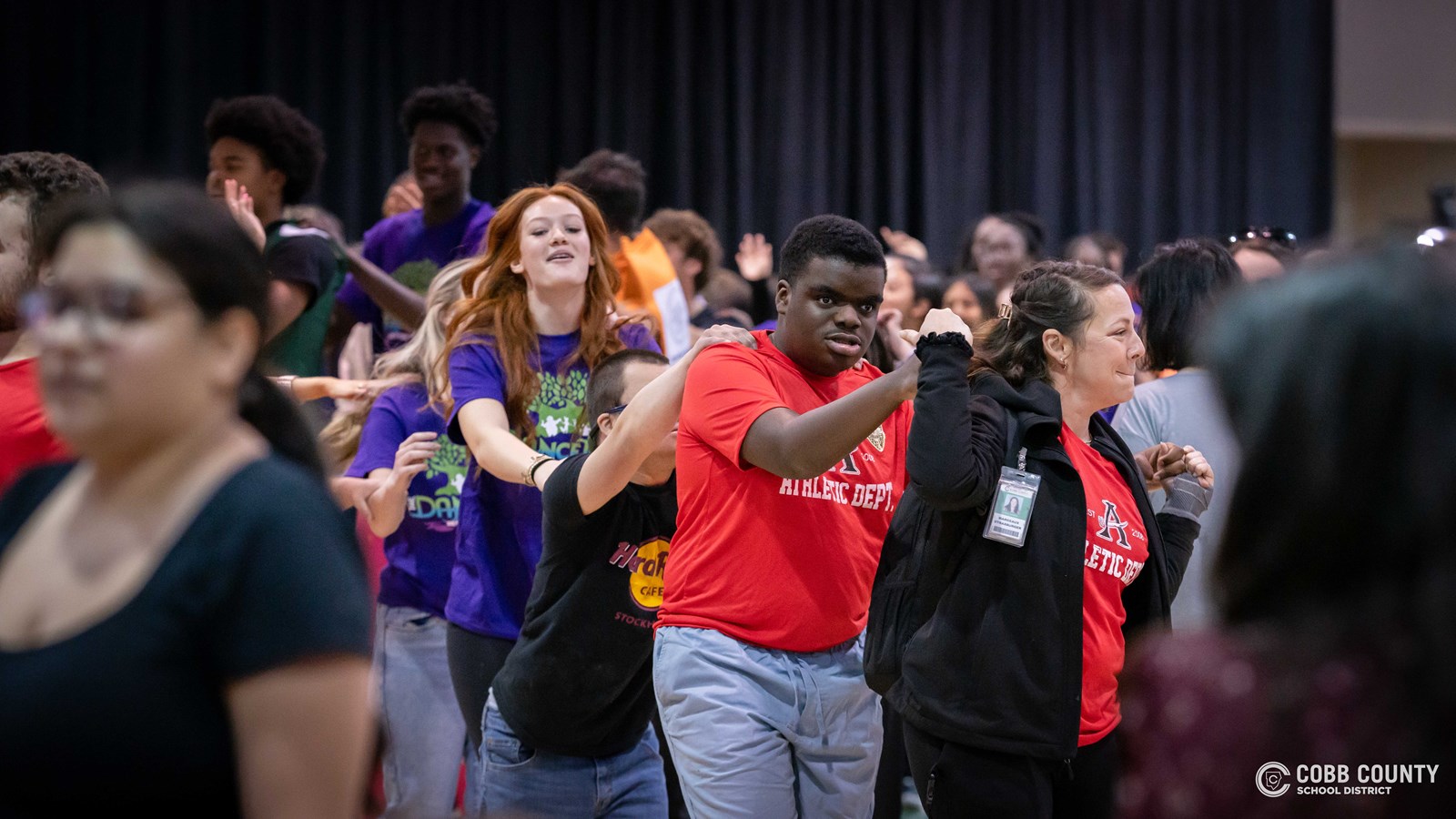 Students and volunteers dancing together at the Cobb Schools Special Education Dance.
