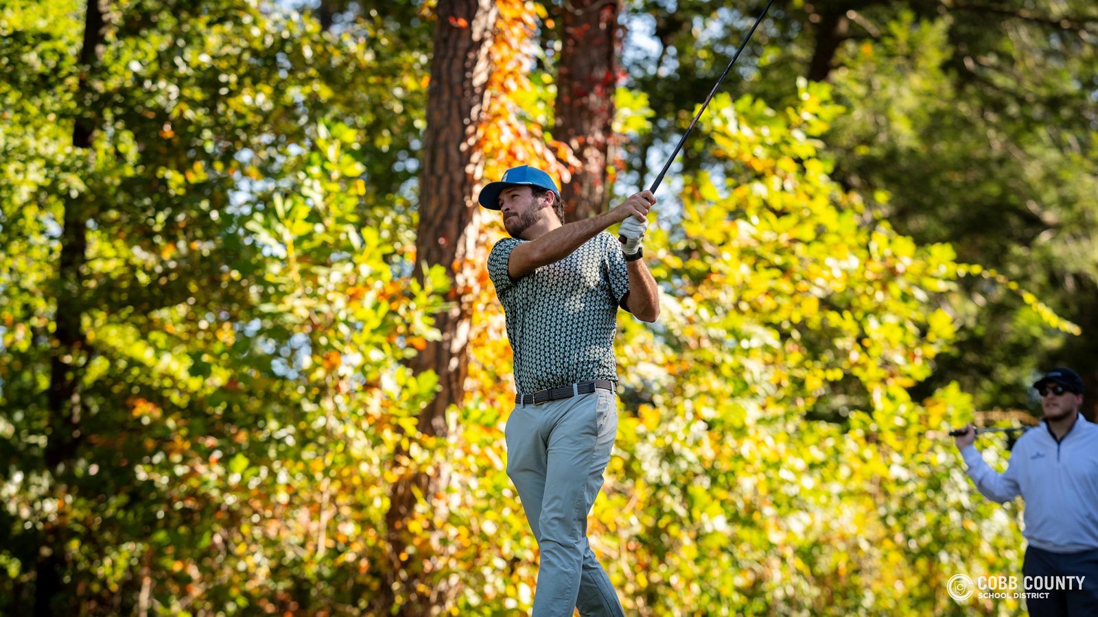 A golfer tees off