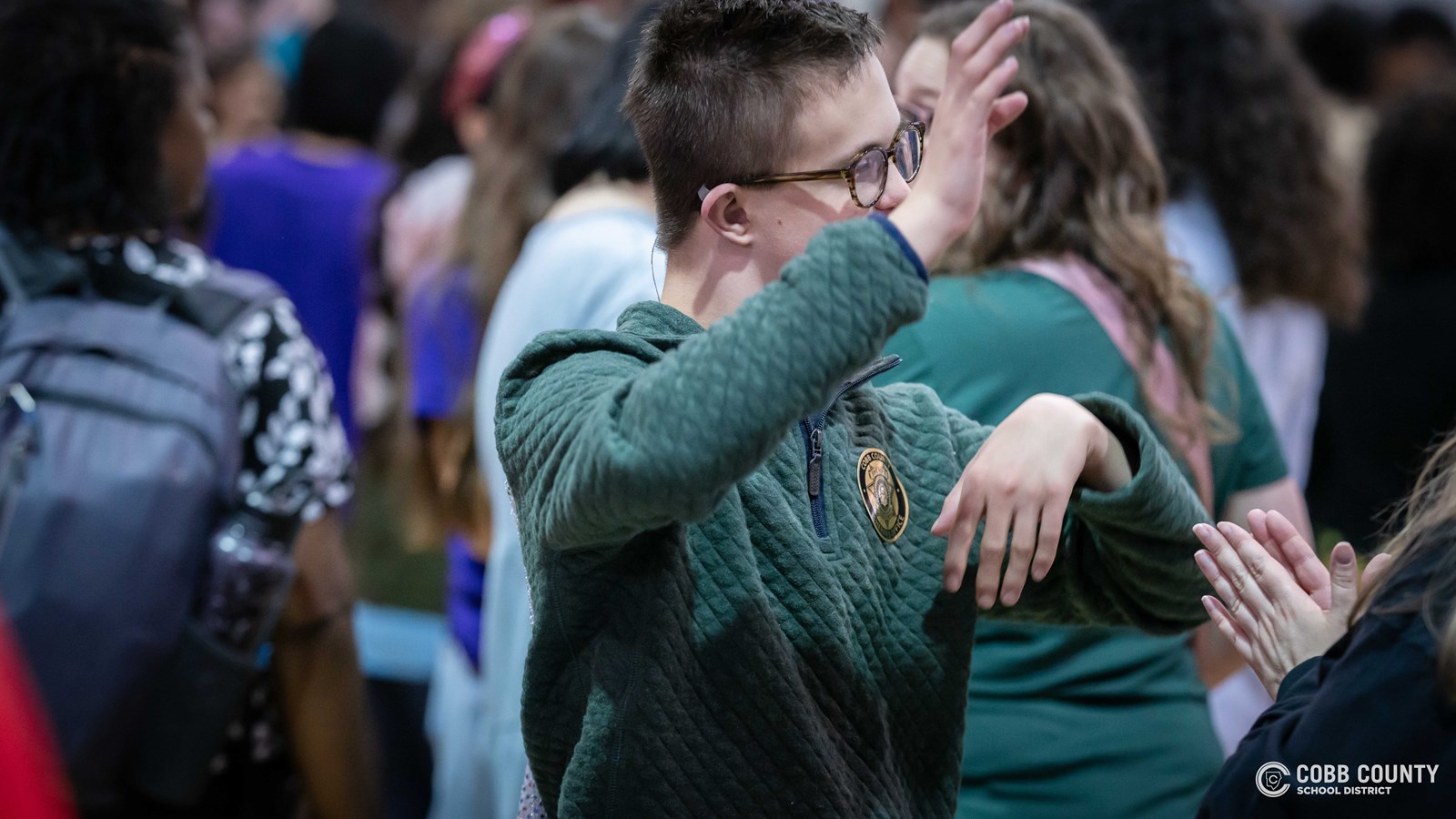 Students and volunteers dancing together at the Cobb Schools Special Education Dance.