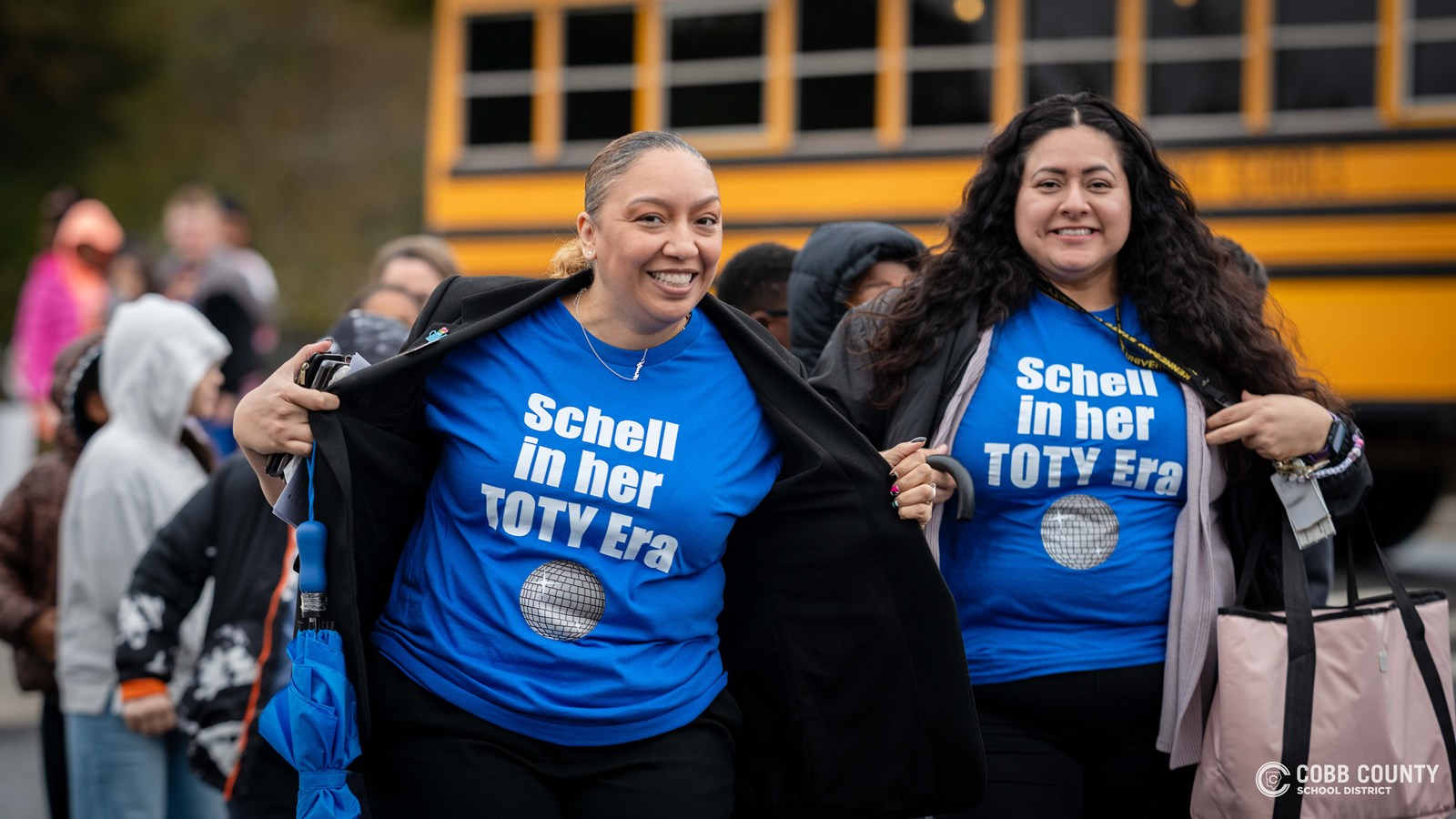 Staff showing off TOTY shirts