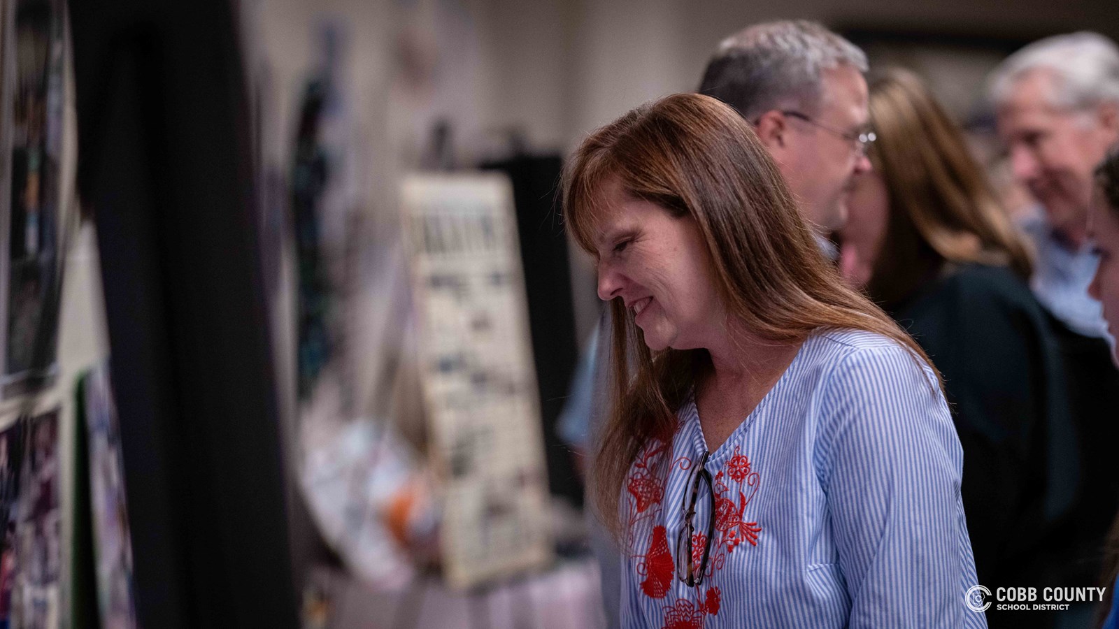 Crowds of students, families, and alumni explore decade-themed displays at Dodgen Middle School’s 50th anniversary STEM Showcase.