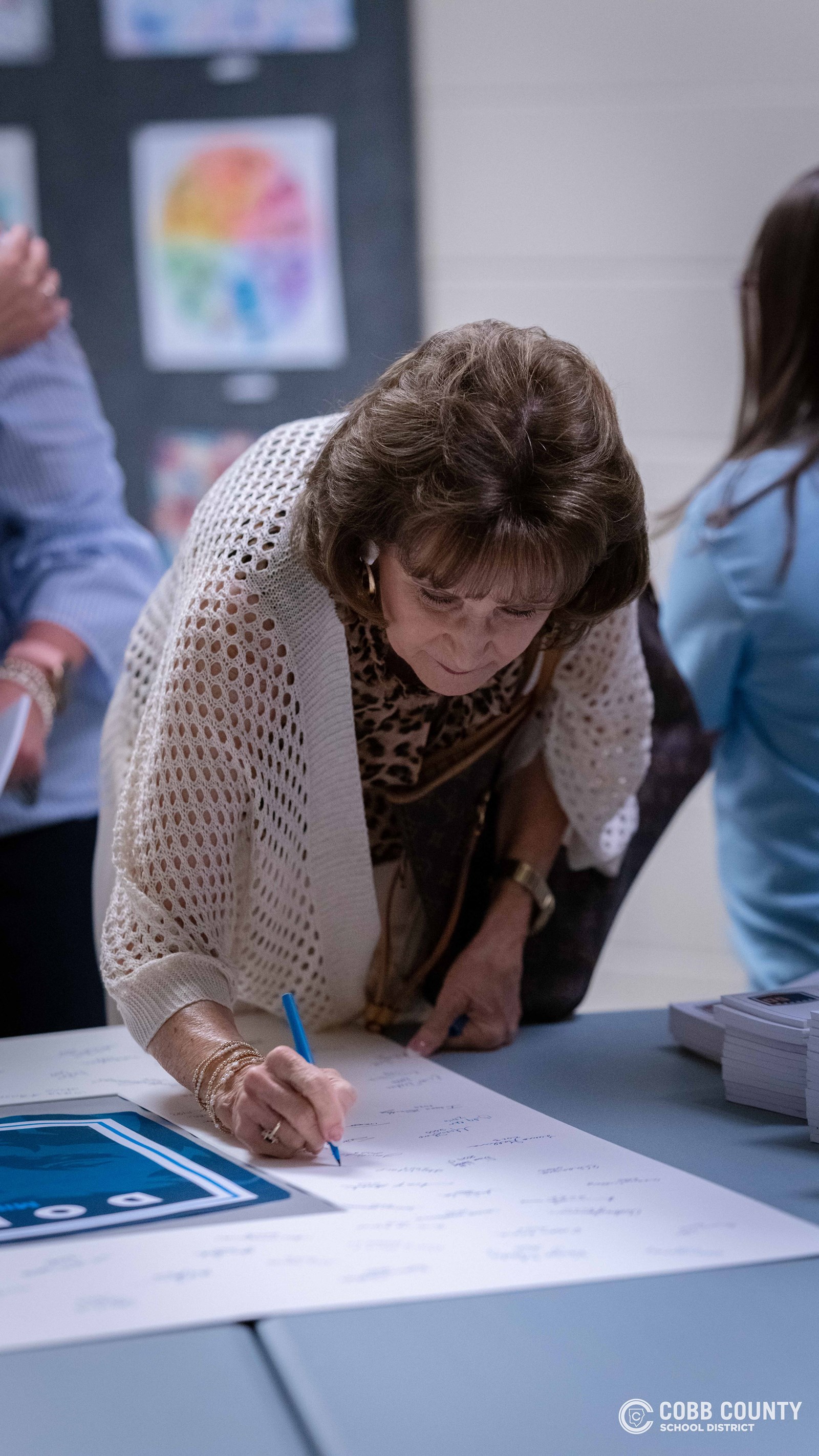 Crowds of students, families, and alumni explore decade-themed displays at Dodgen Middle School’s 50th anniversary STEM Showcase.