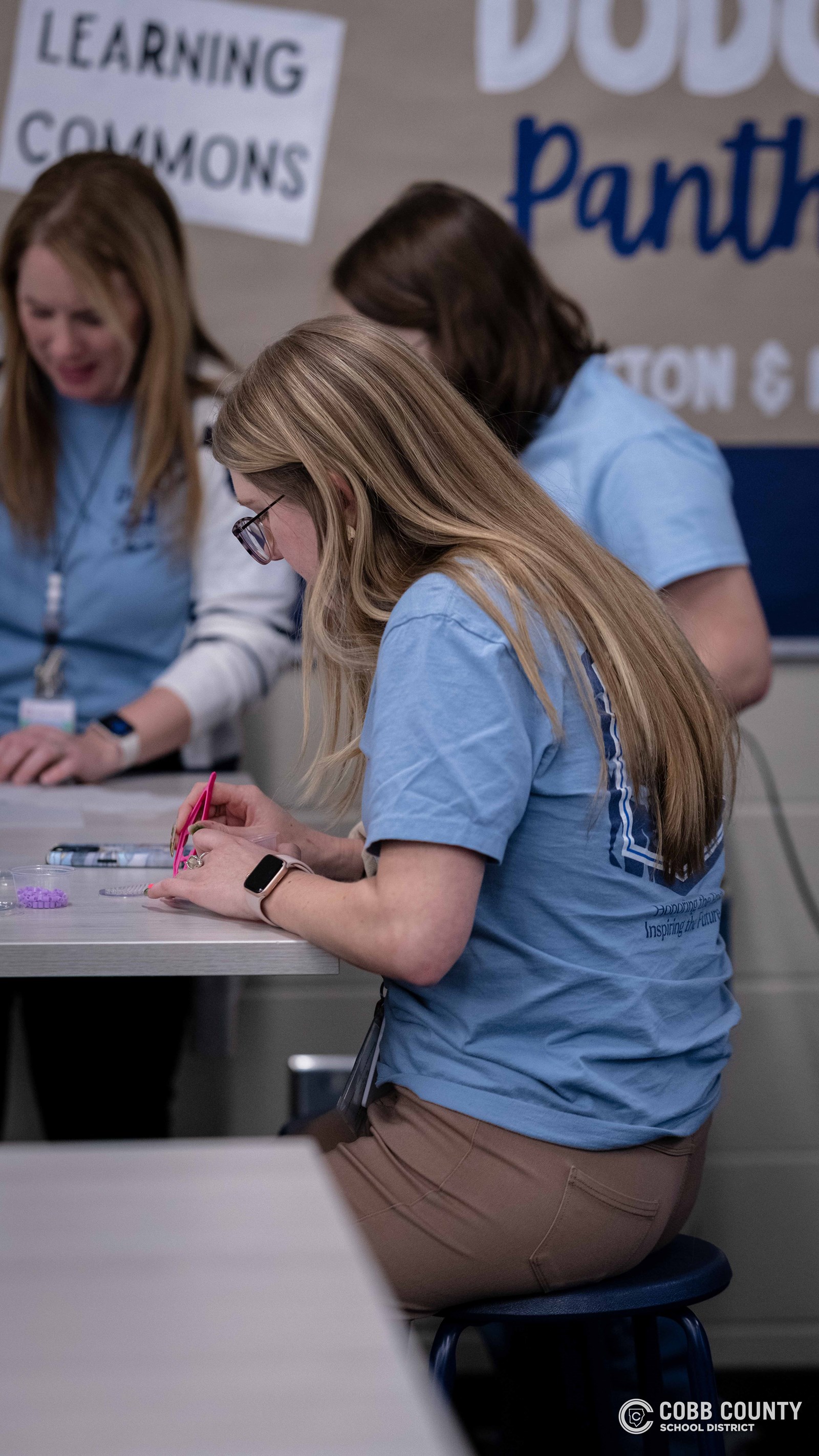 Crowds of students, families, and alumni explore decade-themed displays at Dodgen Middle School’s 50th anniversary STEM Showcase.