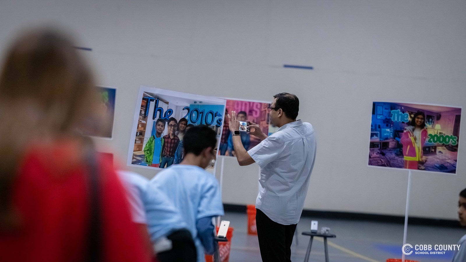 Crowds of students, families, and alumni explore decade-themed displays at Dodgen Middle School’s 50th anniversary STEM Showcase.
