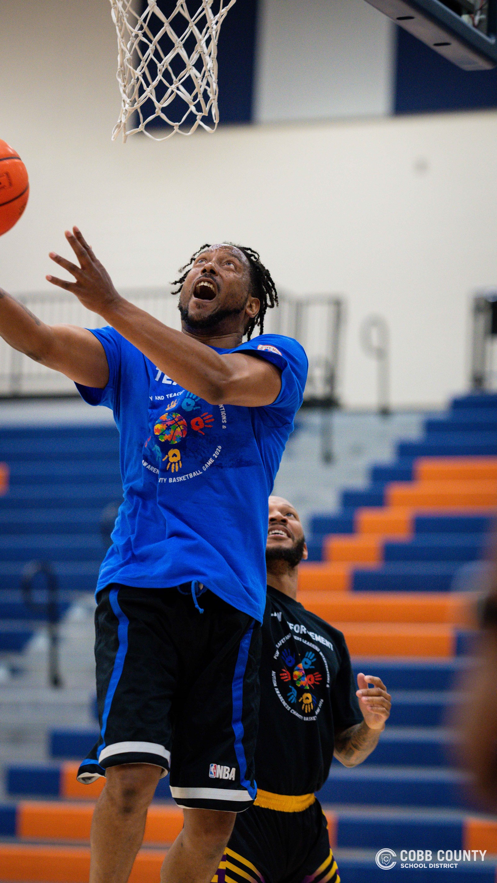A Cobb teacher drives for the scoop shot