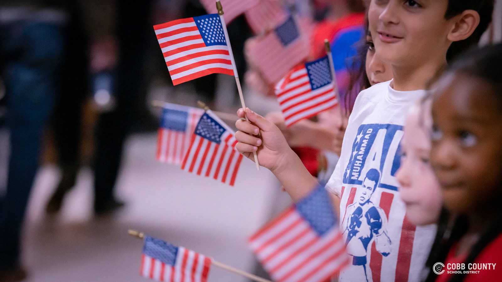 Students waving American Flags