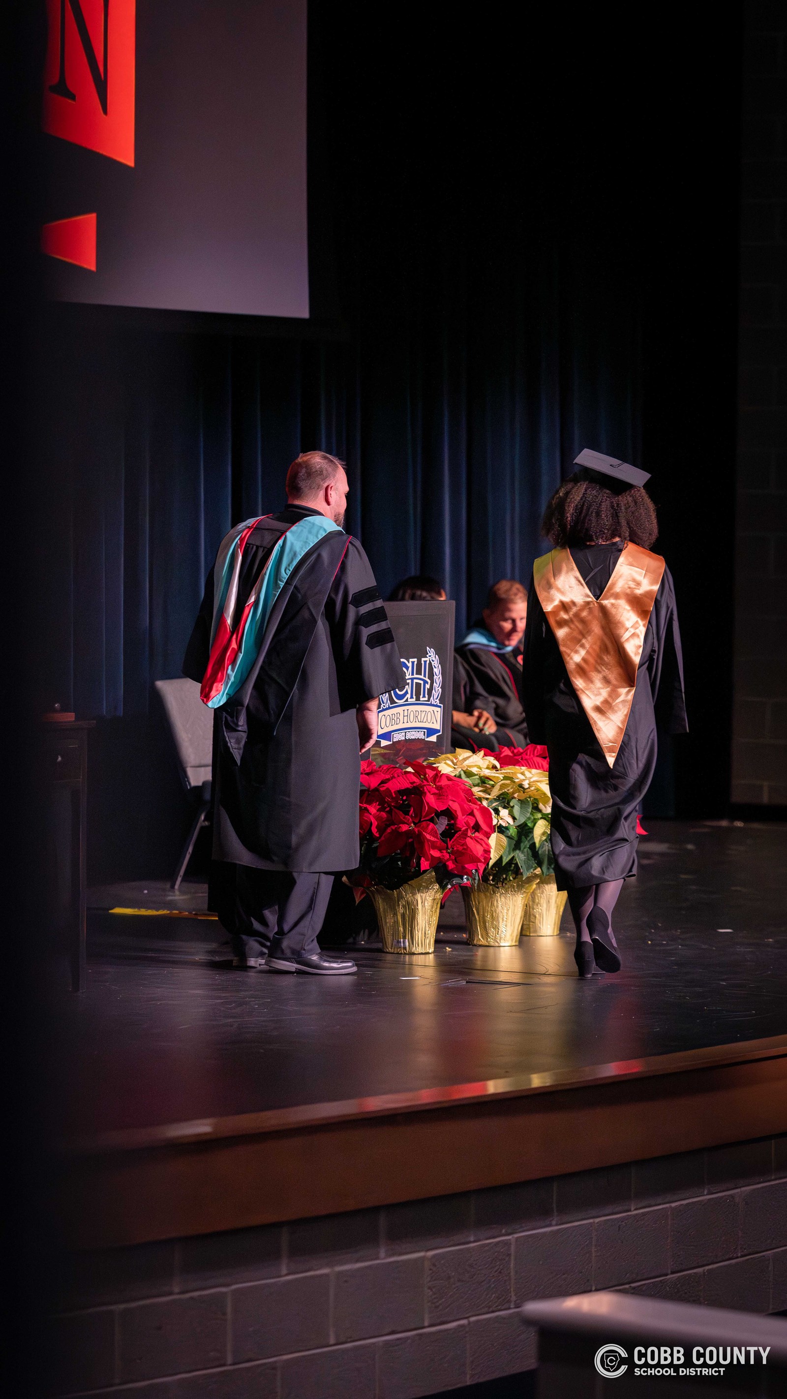 Cobb Horizon High School graduates cross the stage during the school’s December graduation ceremony at Harrison High School.