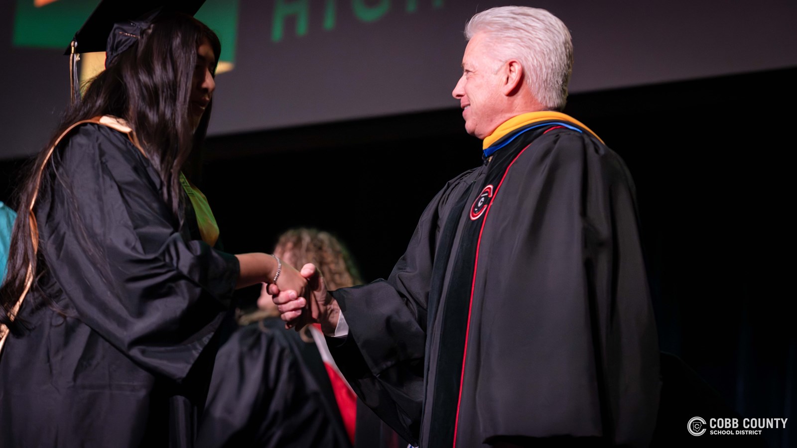 Cobb Horizon High School graduates cross the stage during the school’s December graduation ceremony at Harrison High School.