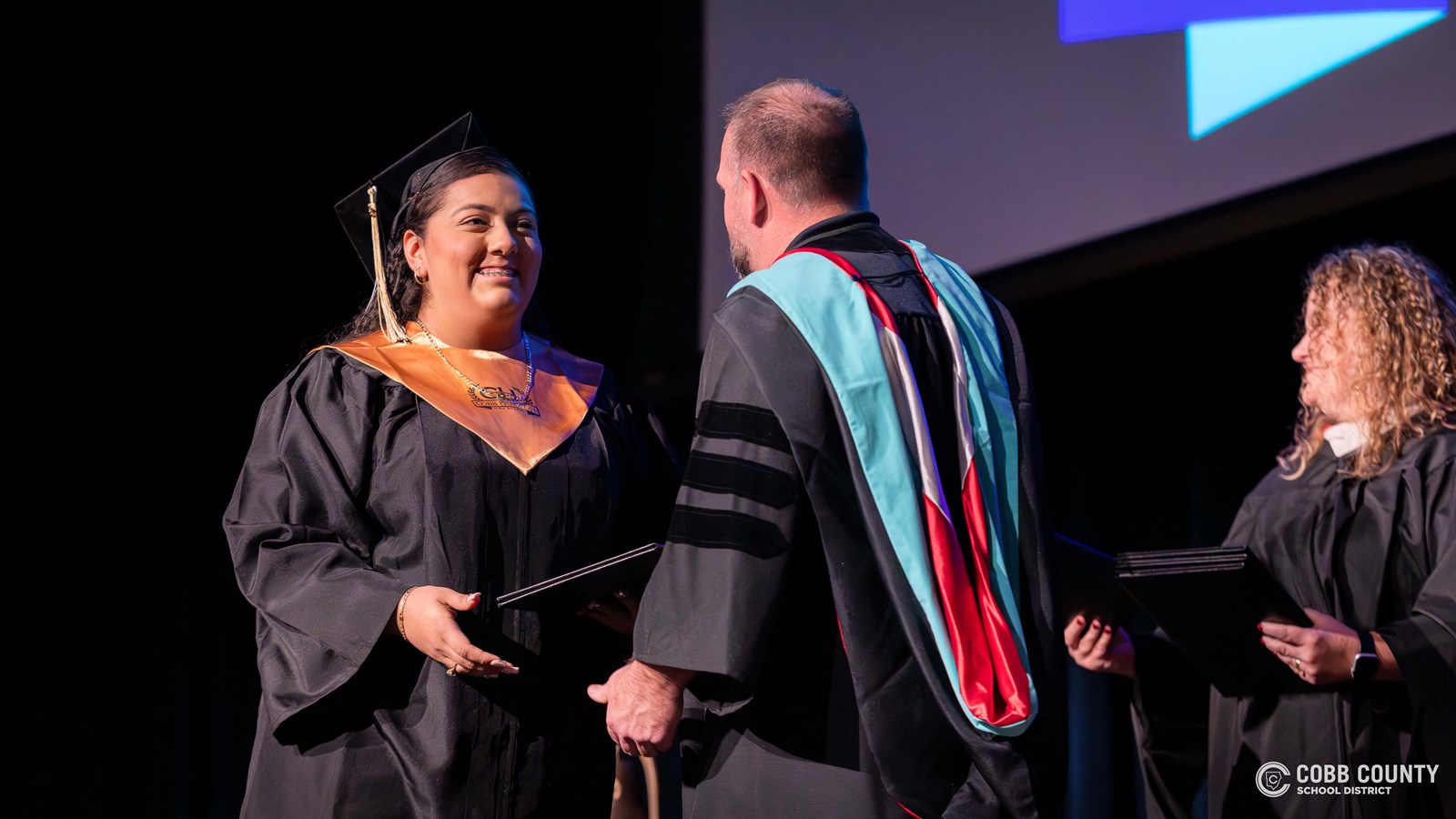 Cobb Horizon High School graduates cross the stage during the school’s December graduation ceremony at Harrison High School.