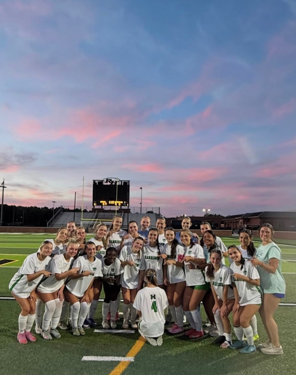 Harrison Hoyas' girls soccer team point to jersey #4 to represent going to the final four