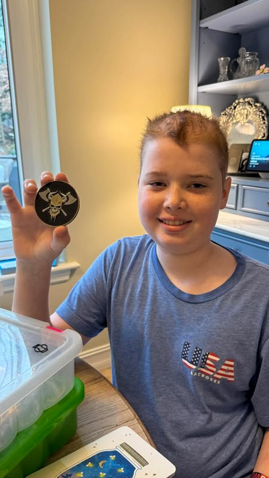 Jackson holding a warrior coin sent to him