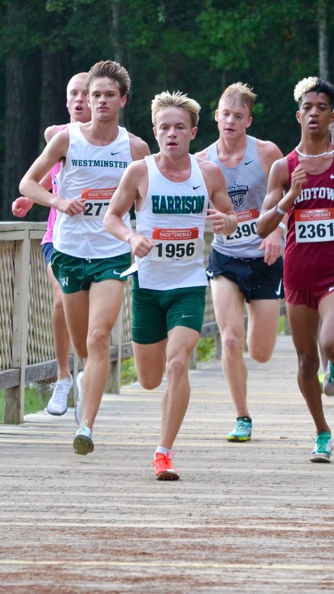 Harrison's Riley Comstock leads the pack in a cross country race