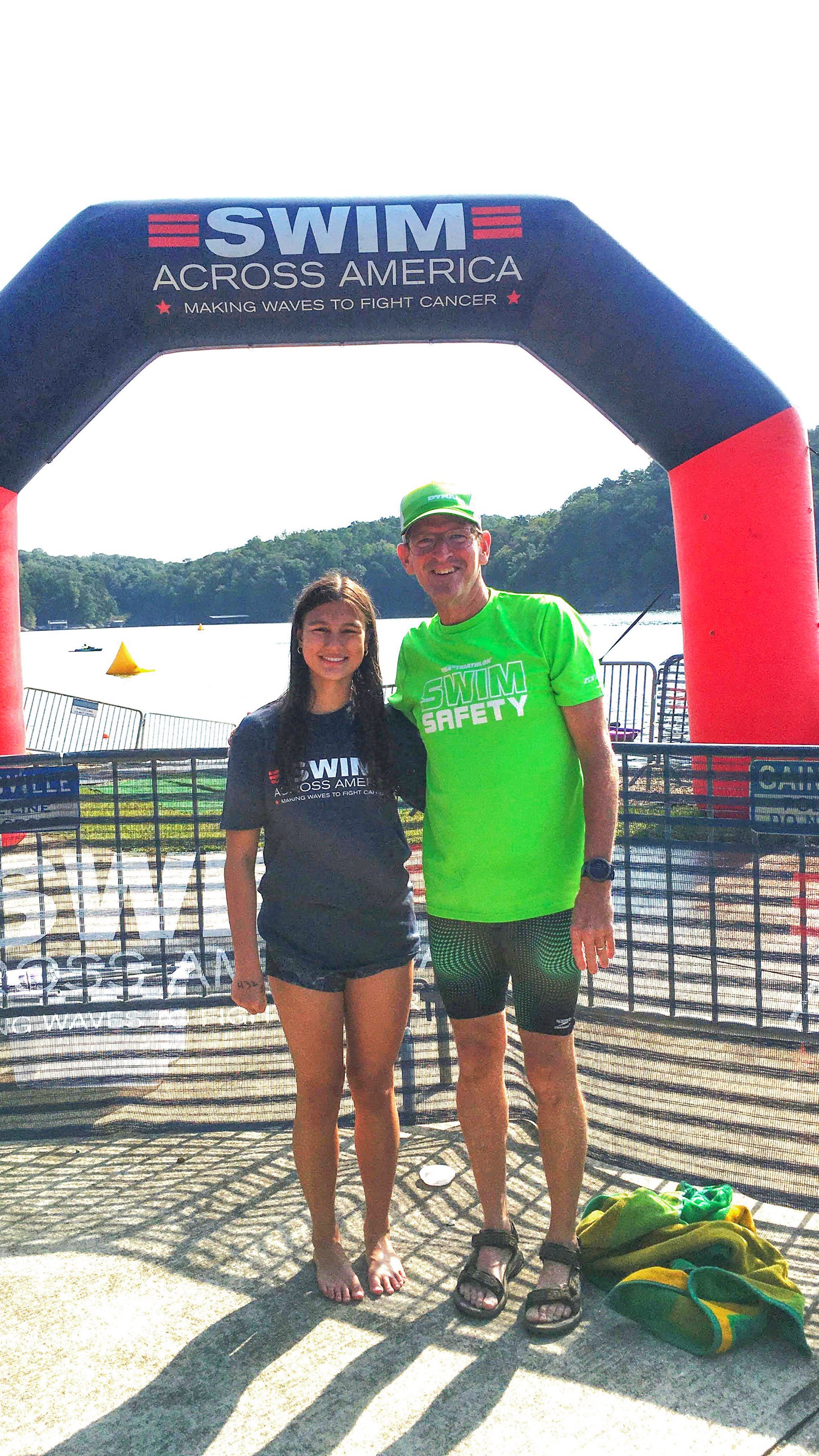 Isabella Parrenas posing with triathlete coach Jeff Gordon at the Swim Across America start line. Already successful as a multi-year state qualifier on the Hoyas Swim Team, Isabella took her talents outside the aquatic center in September 2025.