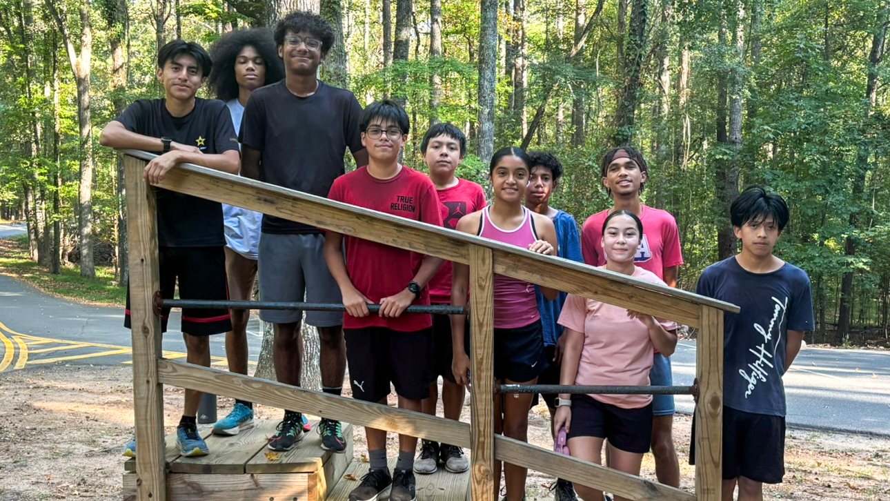 Osborne's Diego Valenzuela (front in red) poses with his XC teammates during a training run