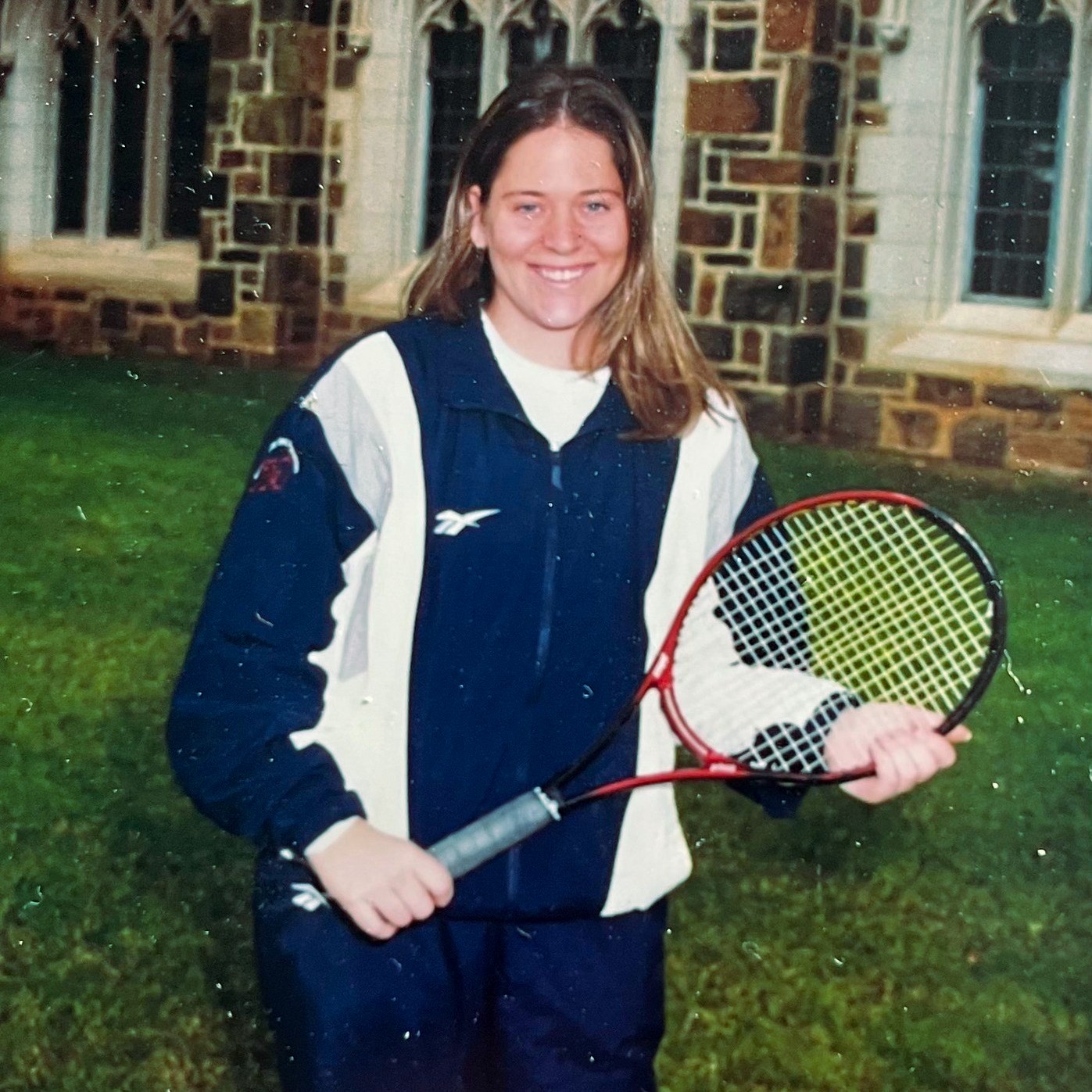 Amanda Ballinger poses for a photo with her tennis racket