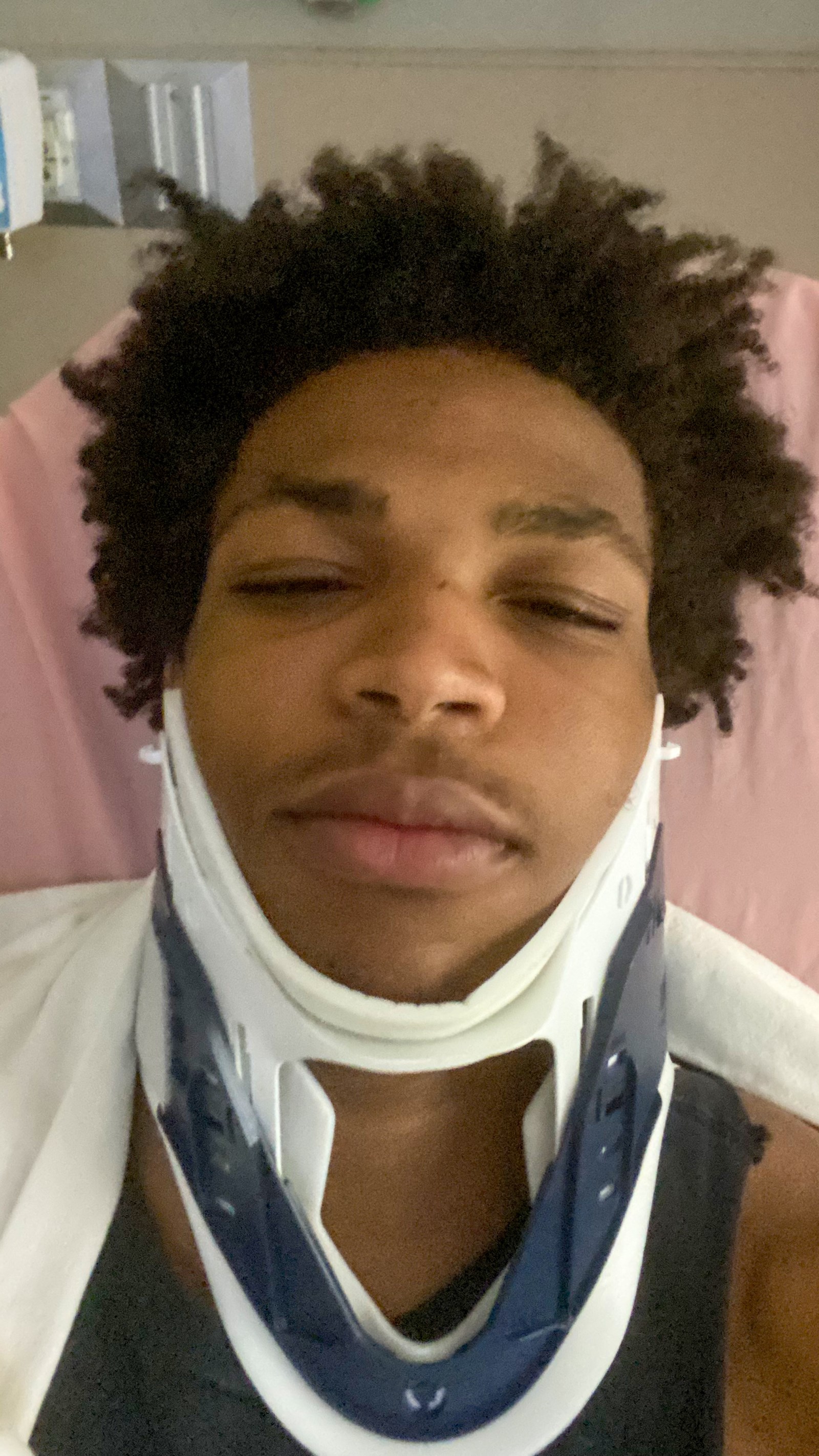 Bin wearing neck brace in hospital
