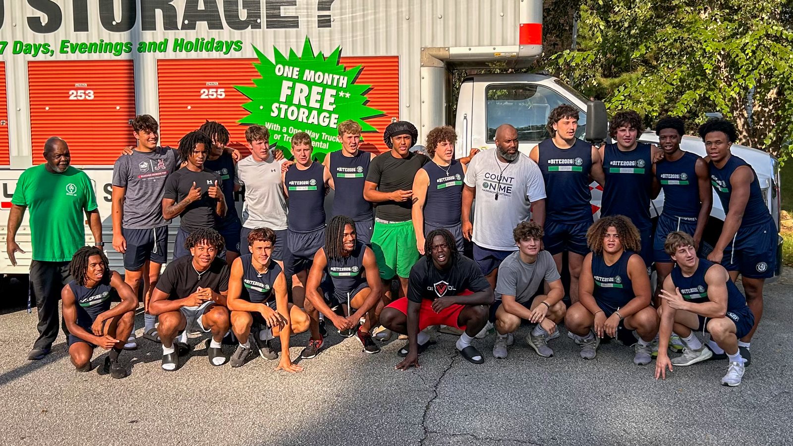 Defensive players from Harrison football pose with Mr. Randall and the rented moving truck