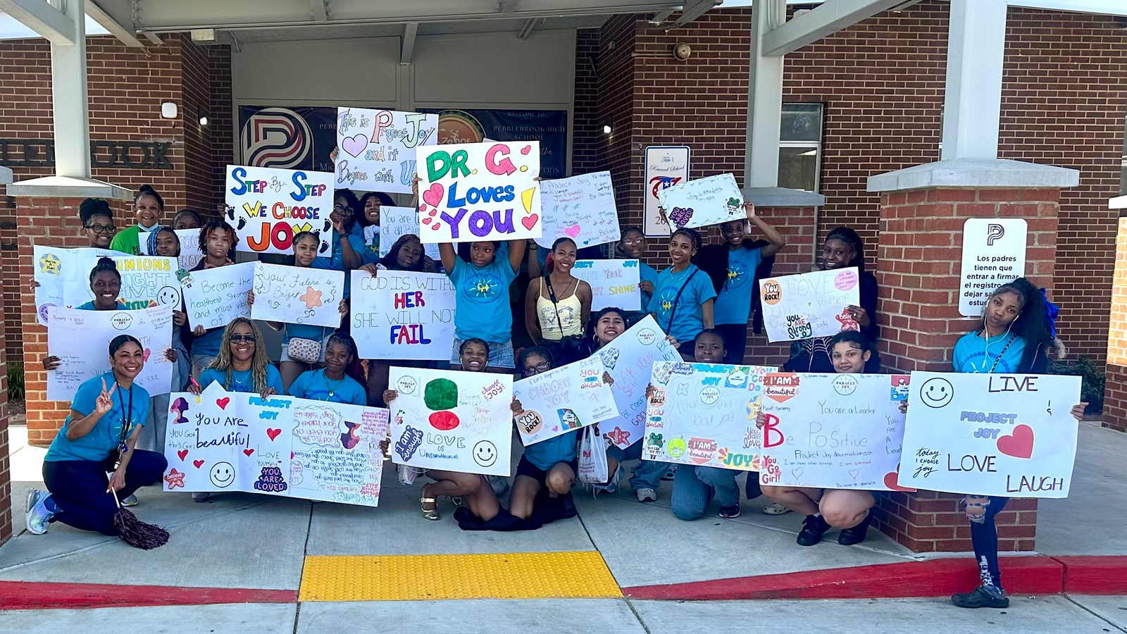 Pebblebrook students and teachers display their signs of affirmation for Project Joy